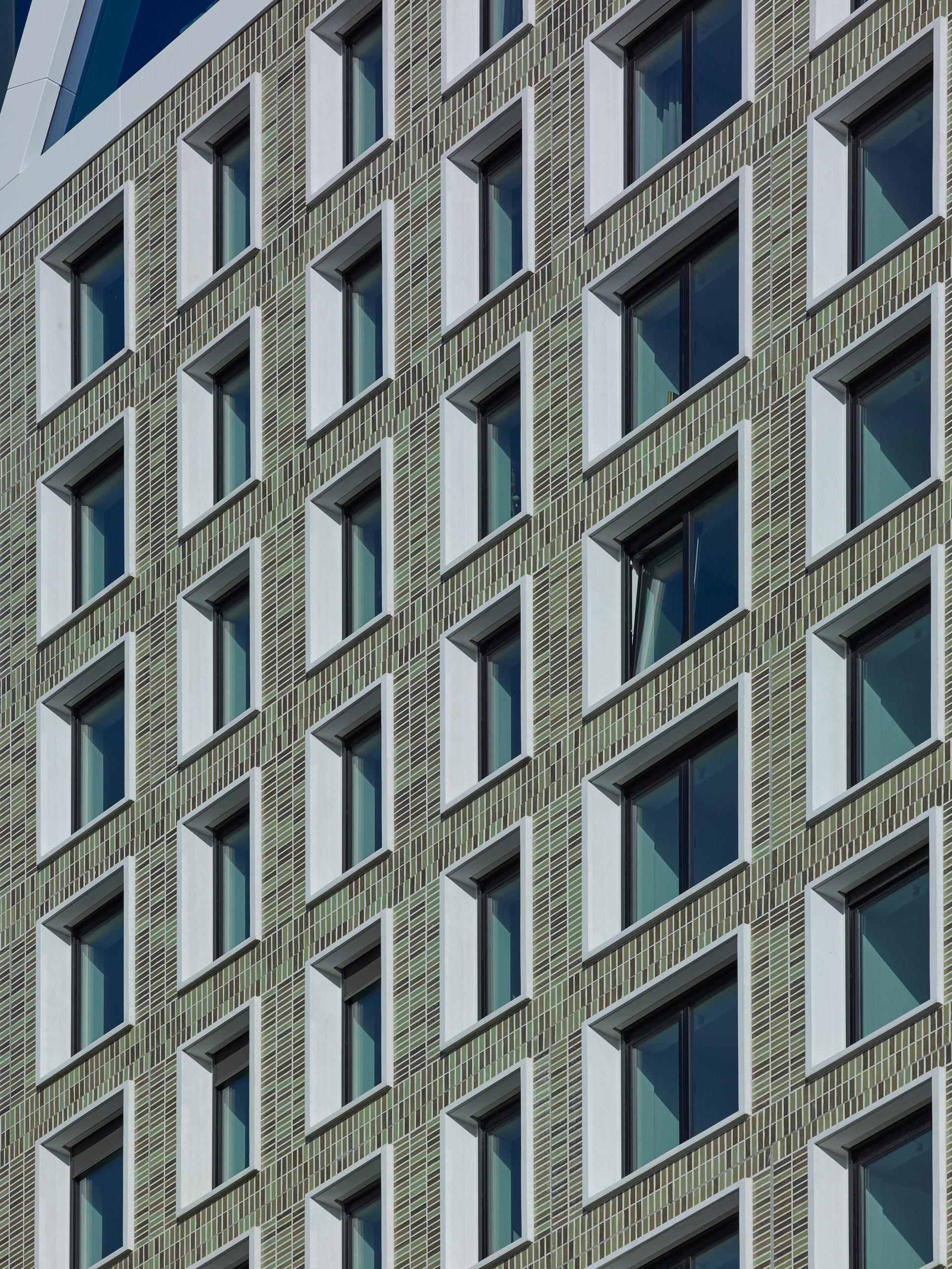 Modern brick façade featuring a symmetrical arrangement of windows, showcasing innovative design from the 2019 Brick Awards.