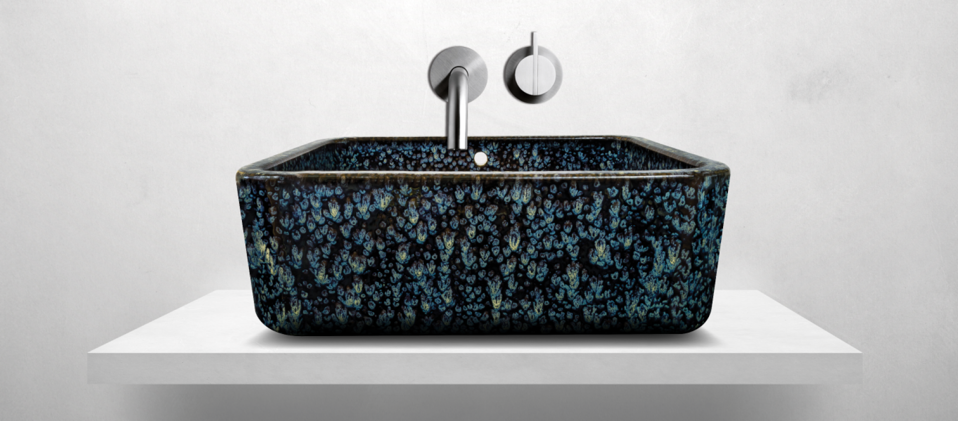 Unique black and blue patterned sink displayed on a minimalist white surface, showcasing innovative design for modern bathrooms.