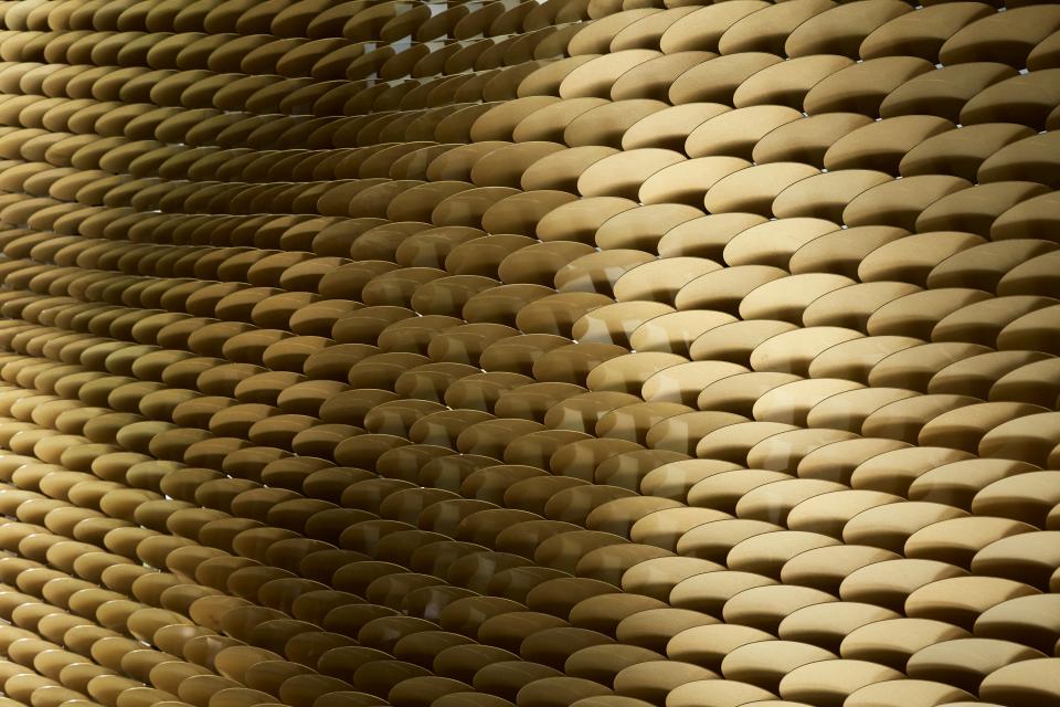 Brass louvres of The Veil by Giles Miller, showcasing intricate patterns and reflective surfaces in architectural design.