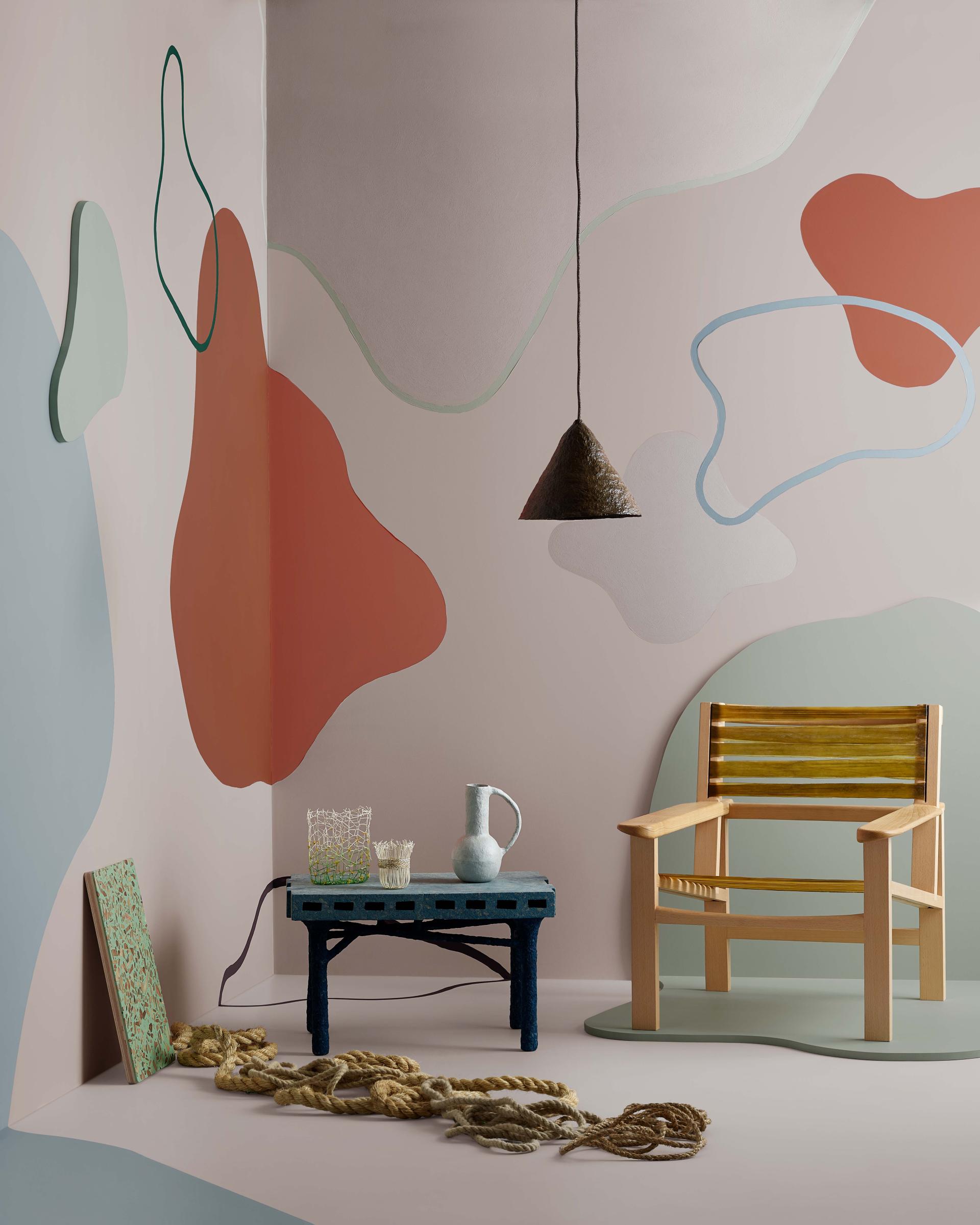 Stylish interior scene featuring abstract wall colors, a wooden chair, and unique decor inspired by Crown Paints' Colour Insights.