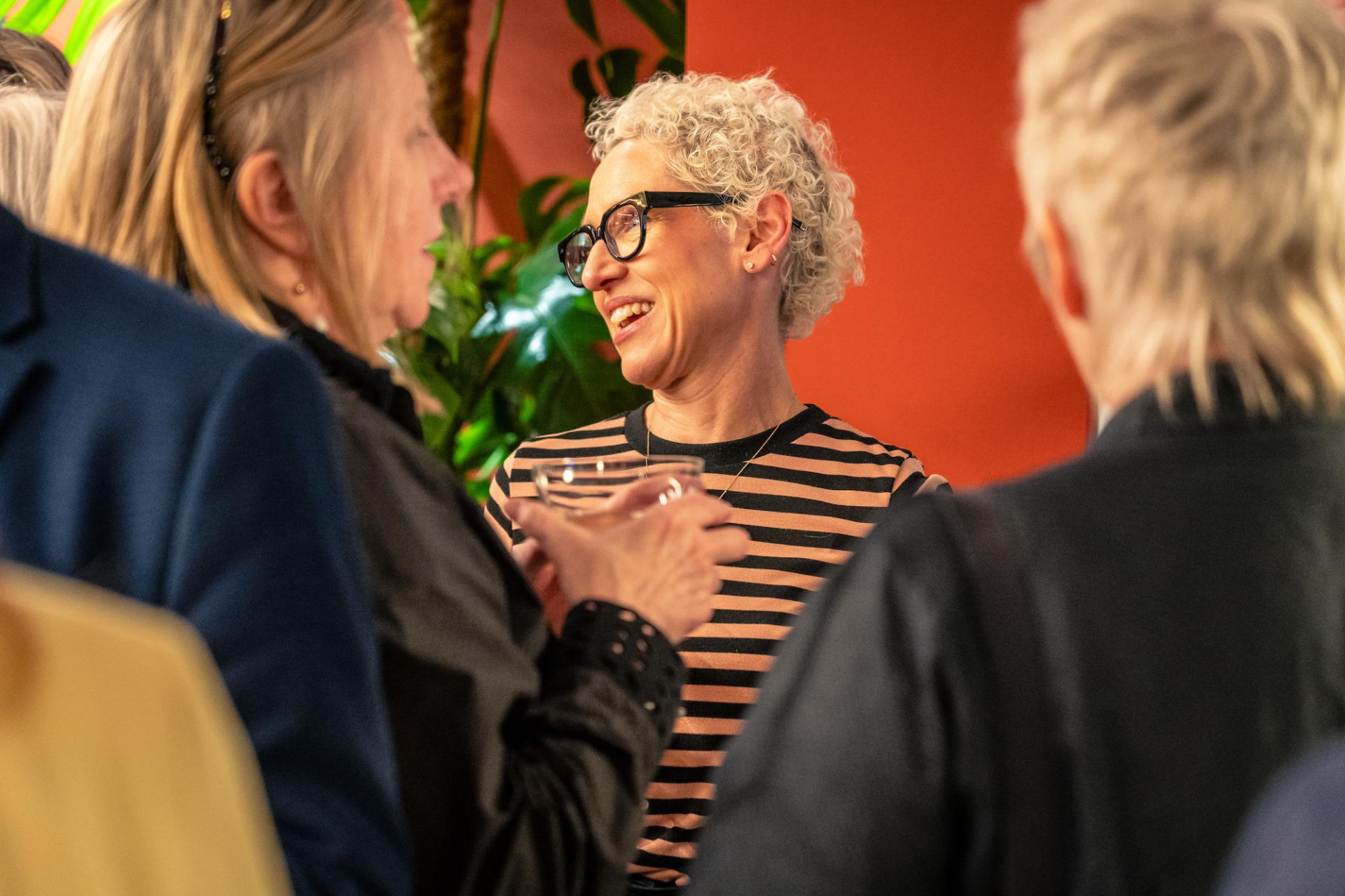 Networking event in Glasgow showcasing positive discussions about the property outlook, featuring engaged attendees.