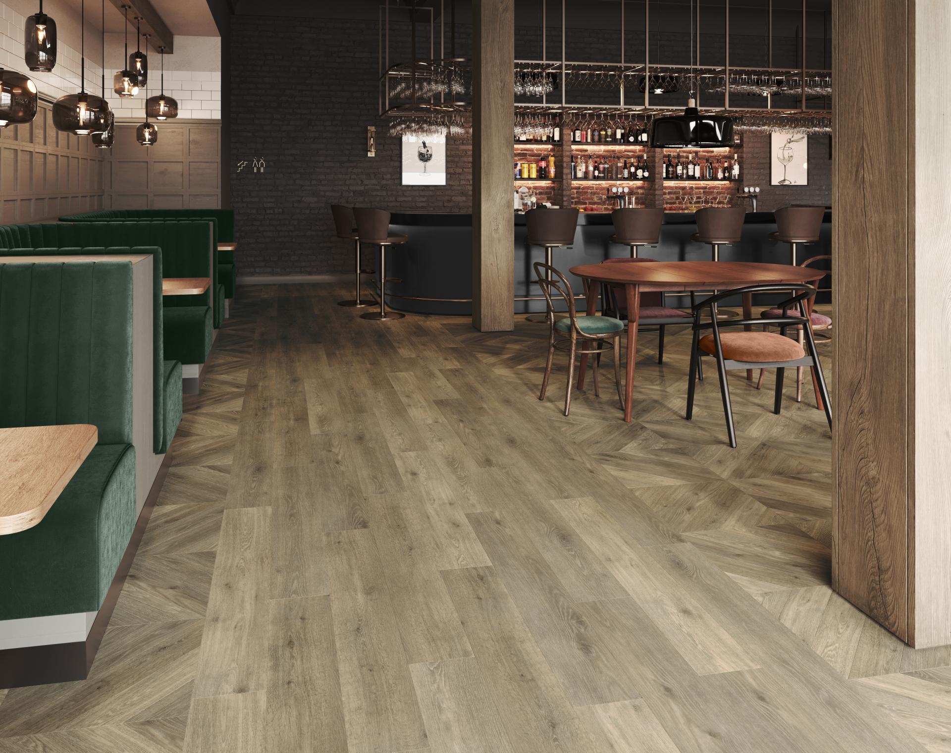 Stylish interior featuring Amtico's Signature LVT flooring, with modern seating and a vibrant bar area, showcasing adaptability.
