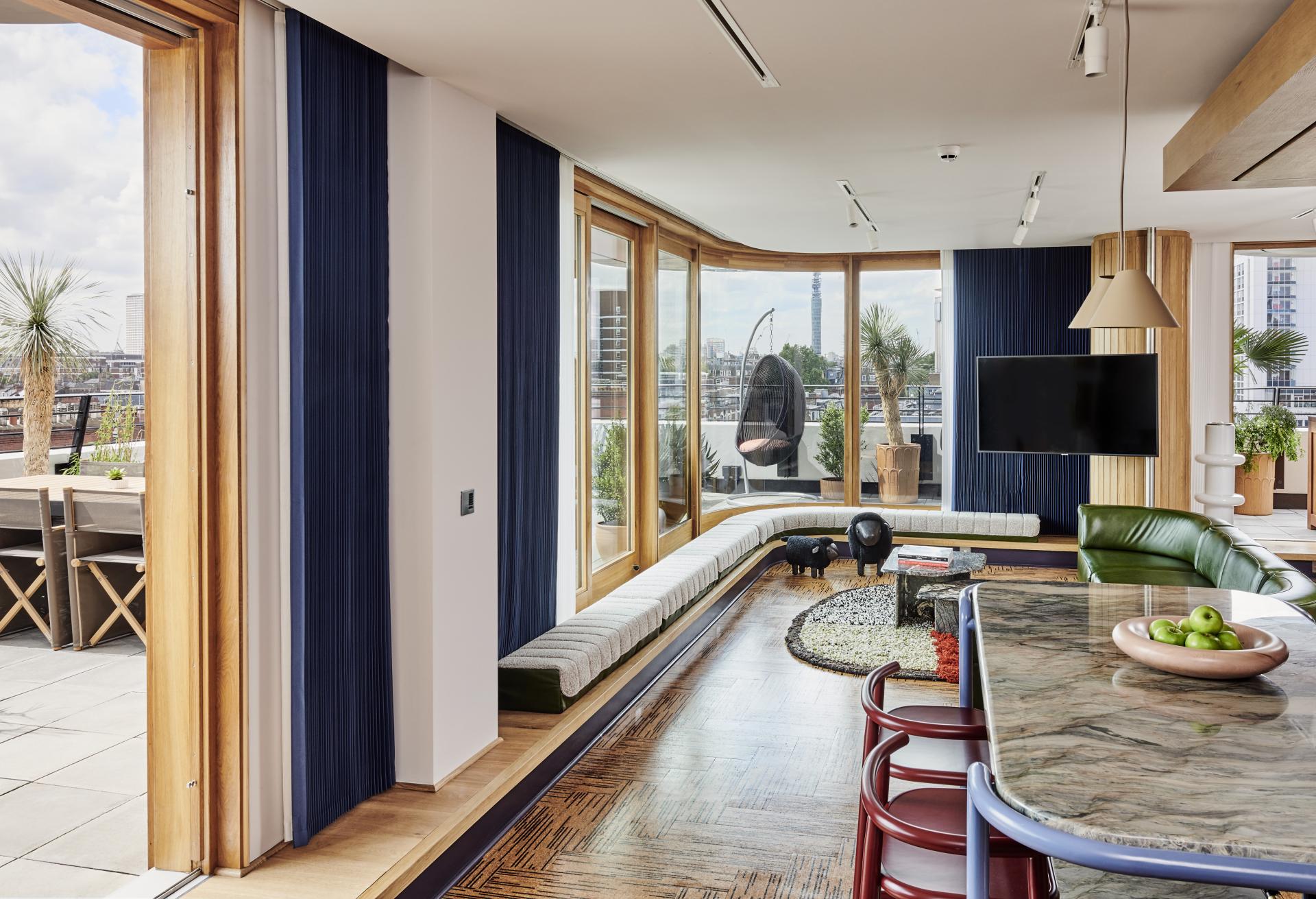 Stylish interior of The Standard, London, featuring contemporary furnishings and large windows with city views.