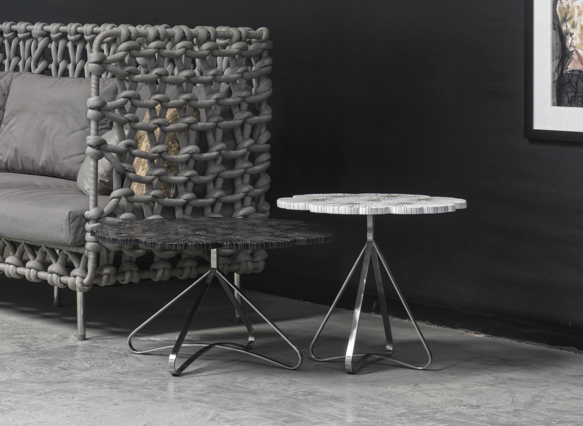 Modern furniture design featuring a unique woven sofa and two artistic side tables, embodying spring's fresh vibrancy.