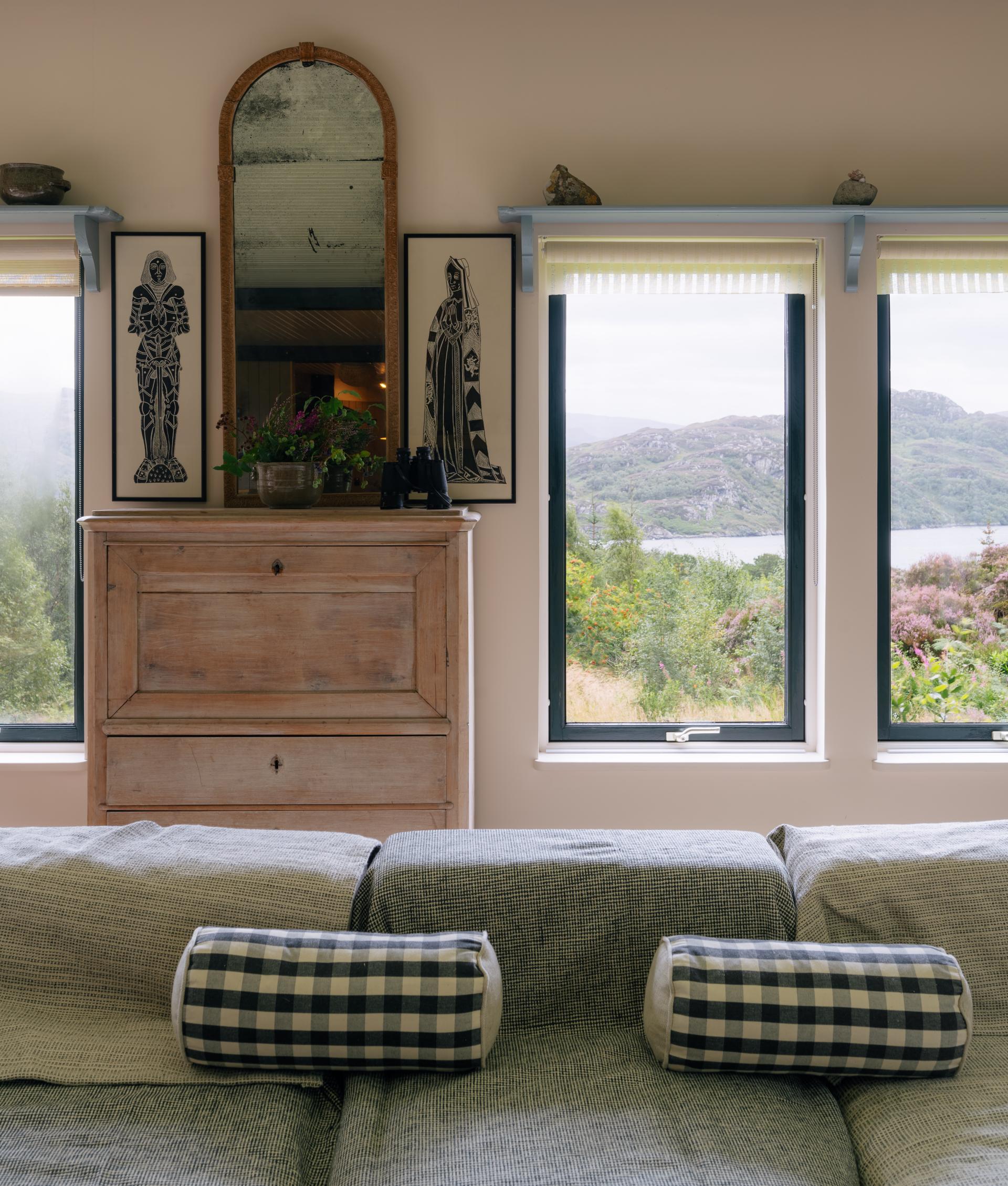 Spacious living area featuring Scandinavian design elements, traditional timber furniture, and art reflecting West Highland vernaculars.