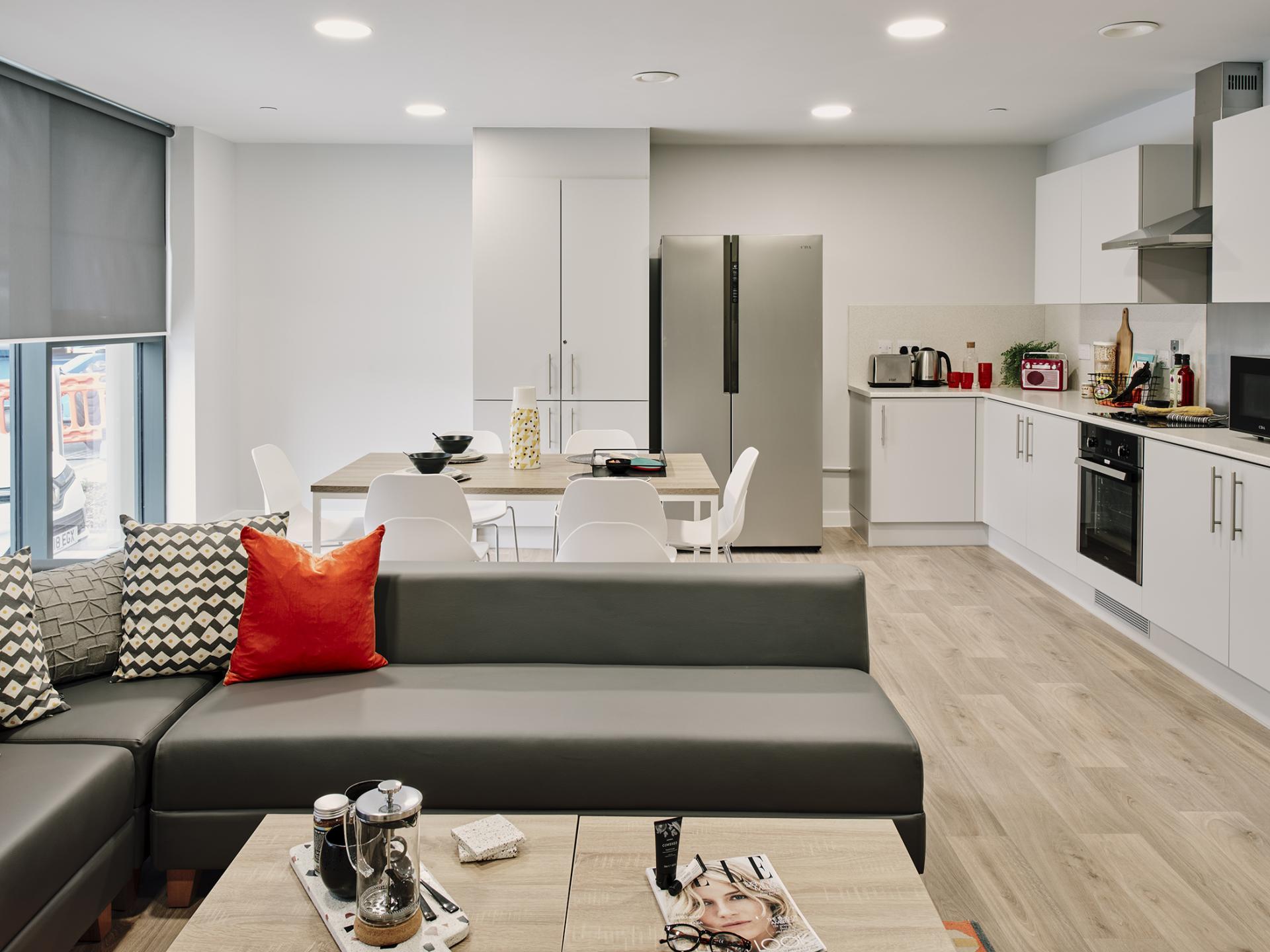 Modern student accommodation interior featuring a stylish kitchenette and dining area in For The Refinery, Leeds.