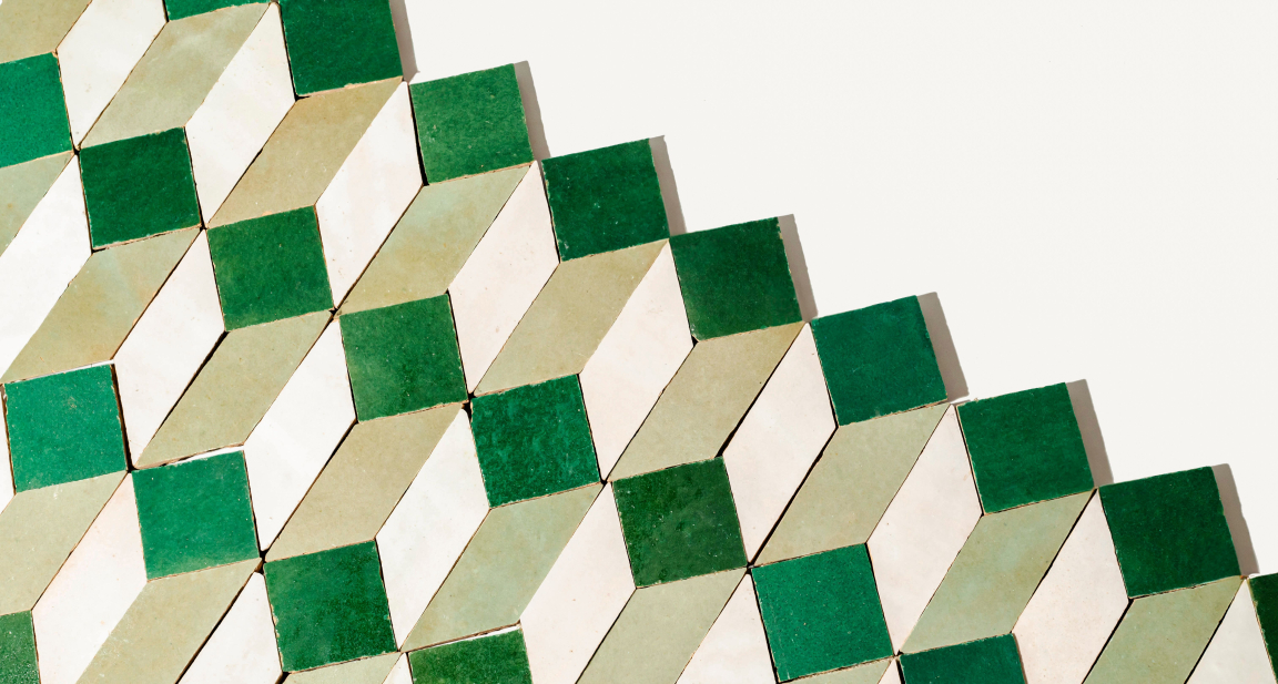 Vibrant green and cream geometric zellige tiles arranged in a playful, modern pattern for dynamic interior design.
