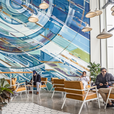 Modern interior of Brew92 cafe features stylish seating and vibrant wall art, creating a cozy atmosphere for coffee lovers.