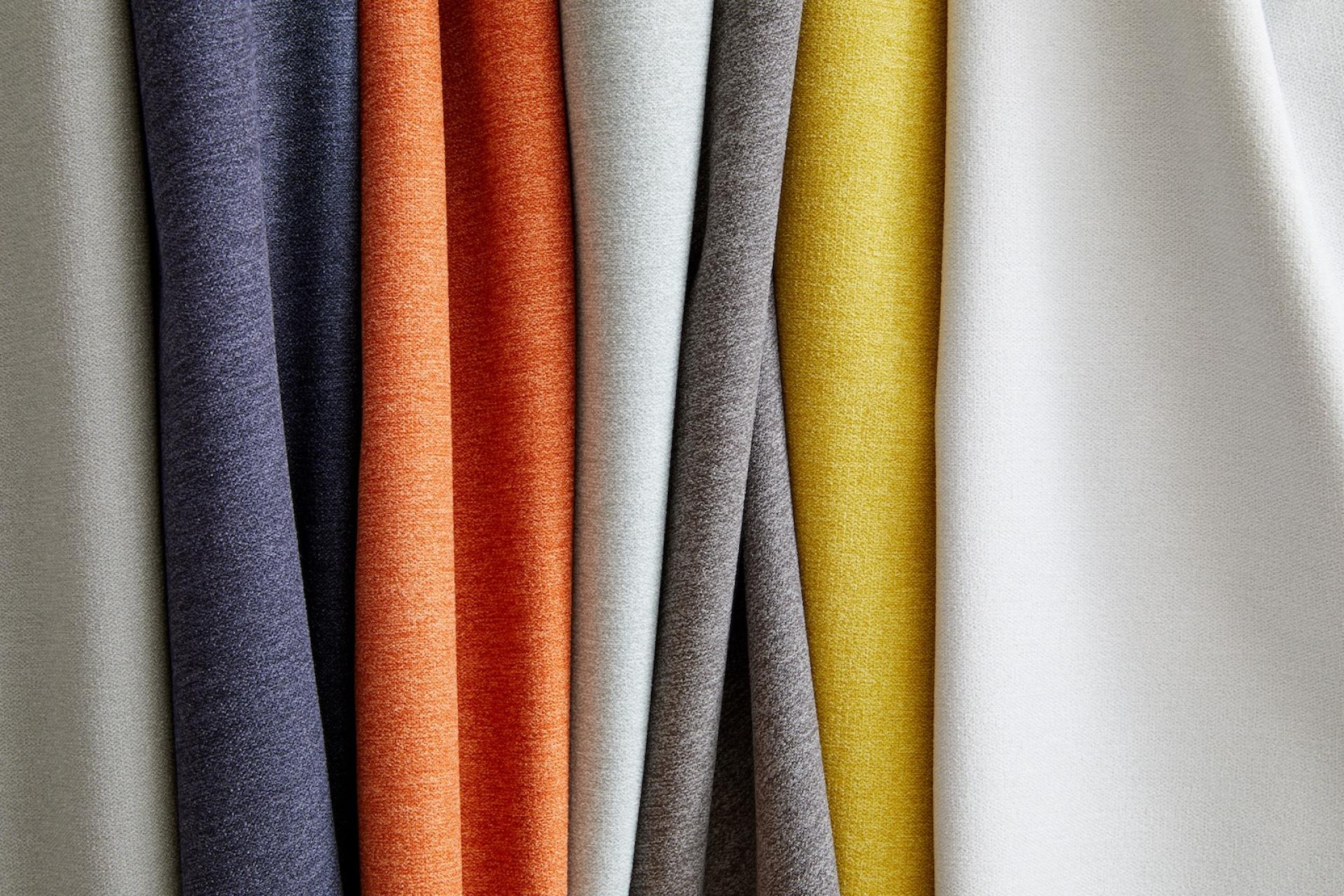 Vibrant selection of Supreen performance upholstery fabrics in various colors, showcasing durability and stain resistance for everyday use.