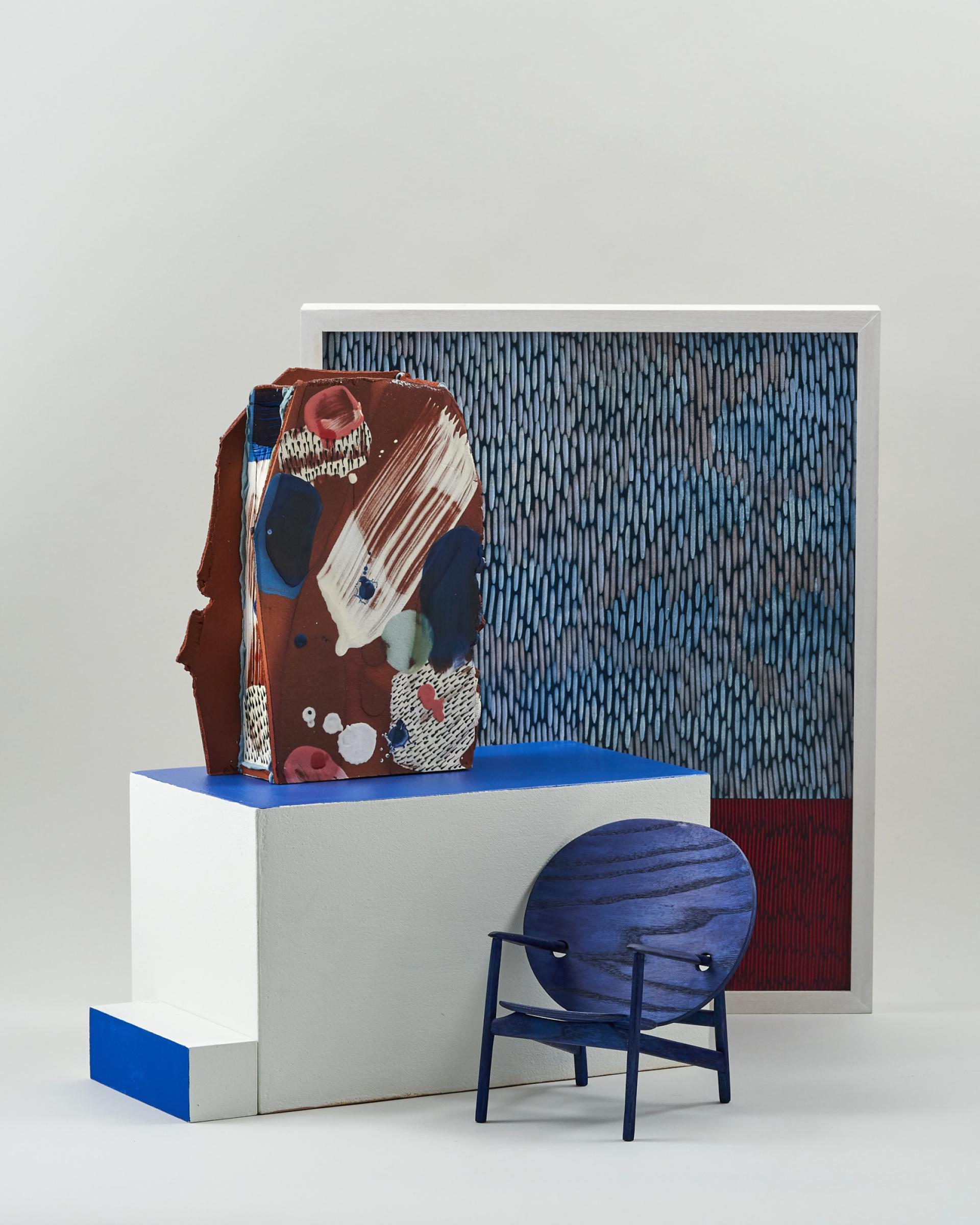 Colorful ceramic piece, modern chair, and abstract artwork displayed at New Designers 2019, showcasing innovative design talent.