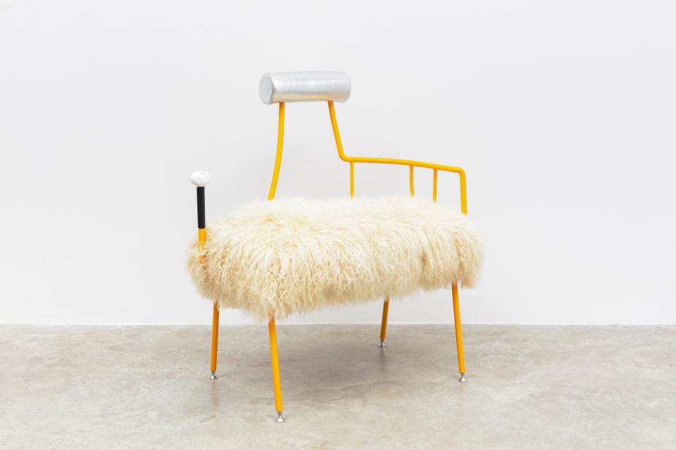 Unique modern chair featuring a fluffy cream seat and vibrant orange metal frame, showcasing contemporary furniture design.