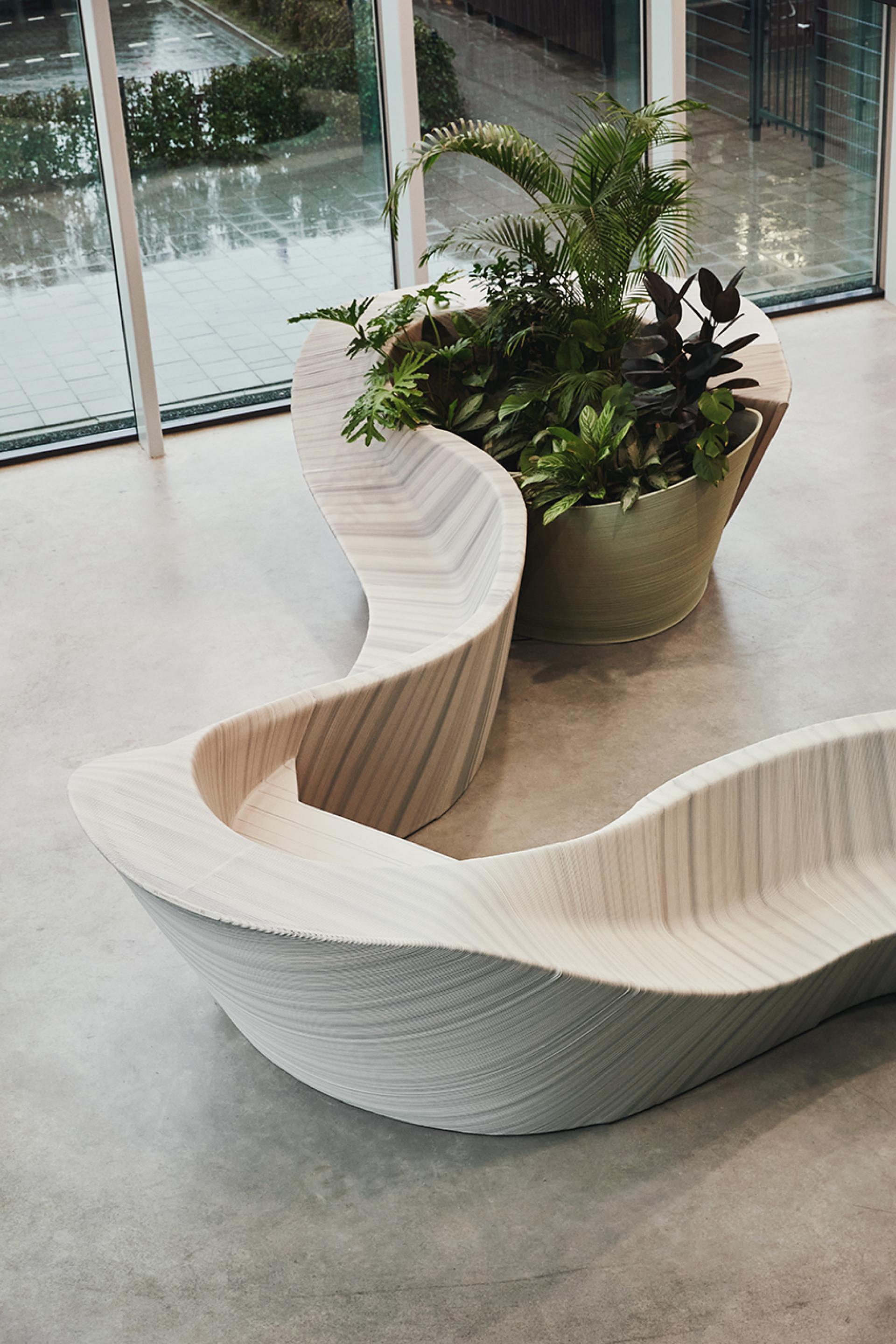 Sculptural entrance furniture design integrating planters, featuring flowing shapes and natural materials by The New Raw.