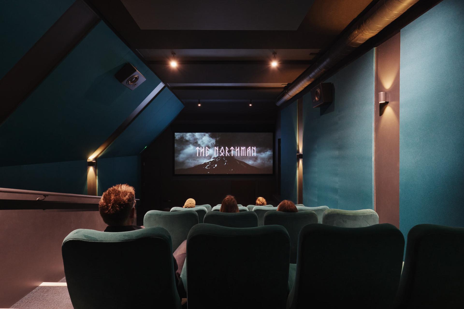 Cinematic interior of The Lexi cinema featuring plush seating and a screening of "The Northman" on the big screen.