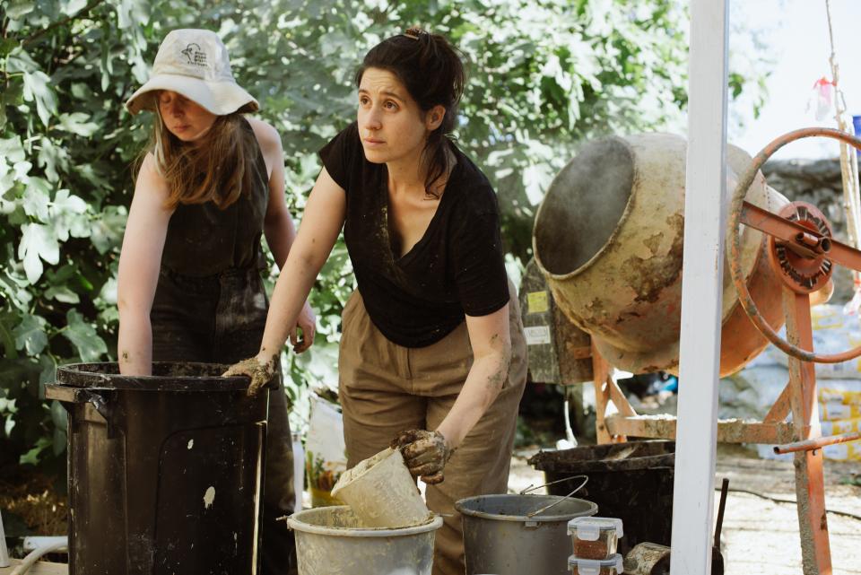 Designers preparing materials for a 3D printing project at Jerusalem Design Week, showcasing innovative building techniques.