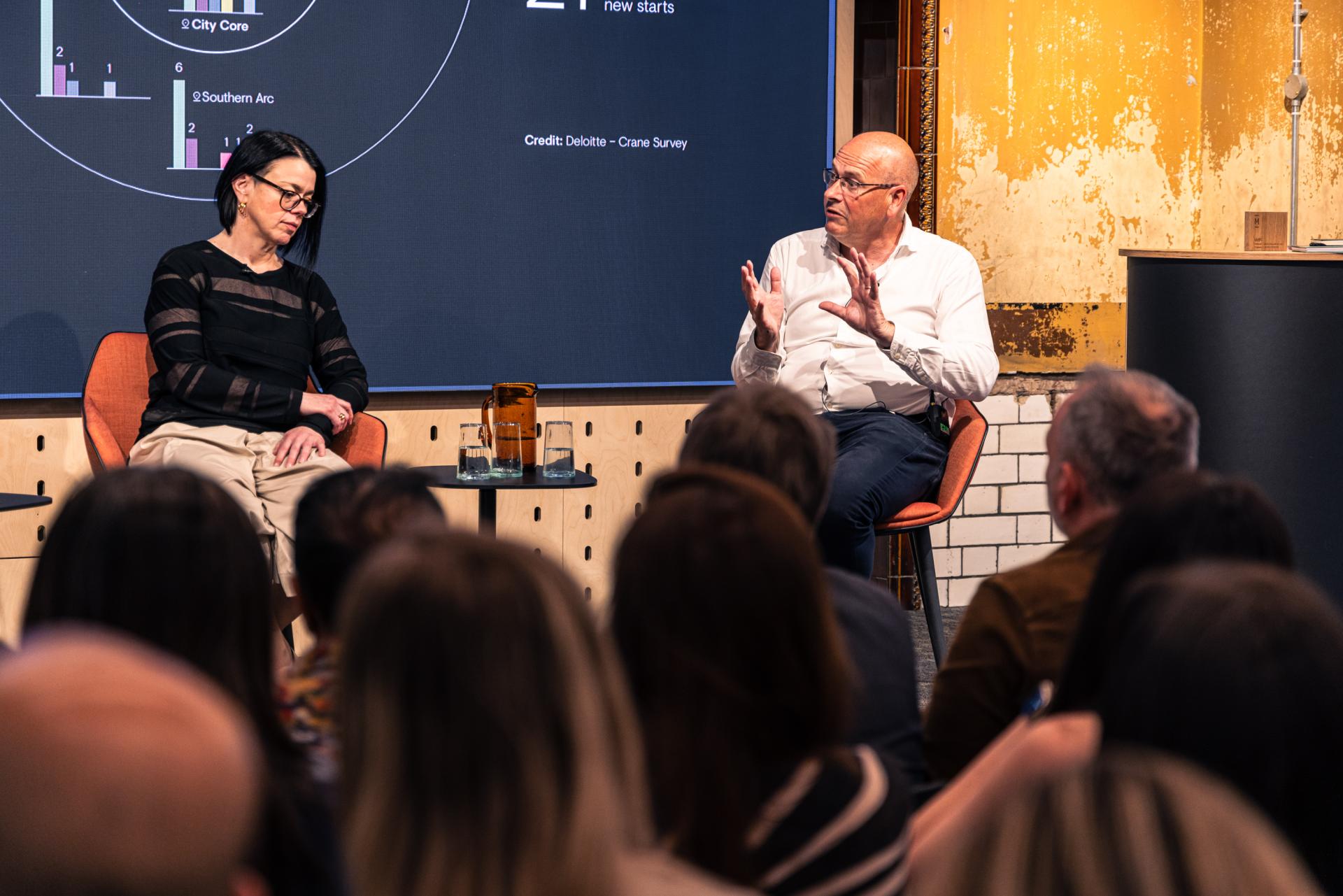 Engaging discussion at Manchester property seminar, highlighting growth trends in real estate market dynamics.