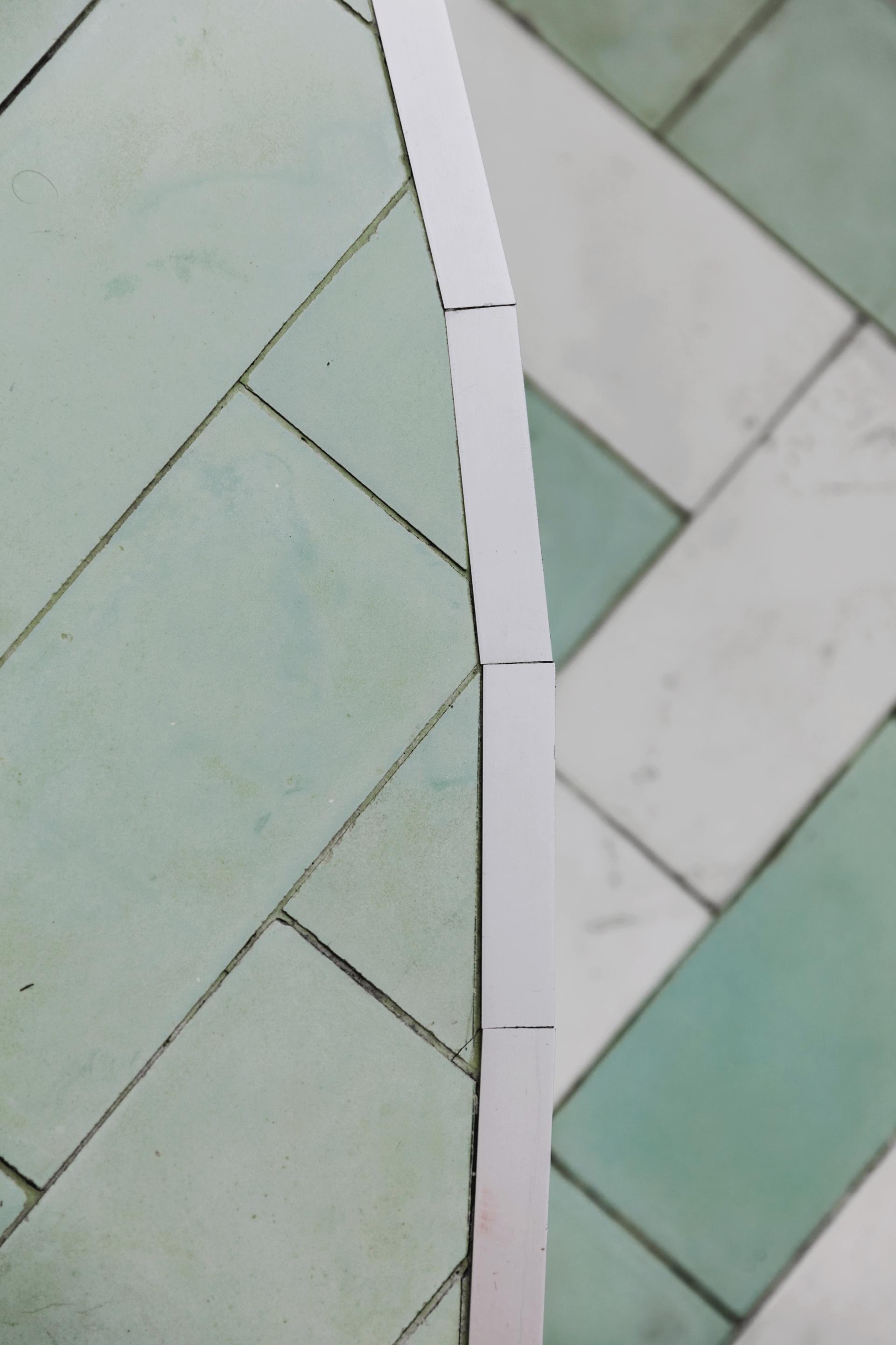 Art Deco tiled flooring in green and white, showcasing a stylish interior design for an Italian restaurant in Soho.