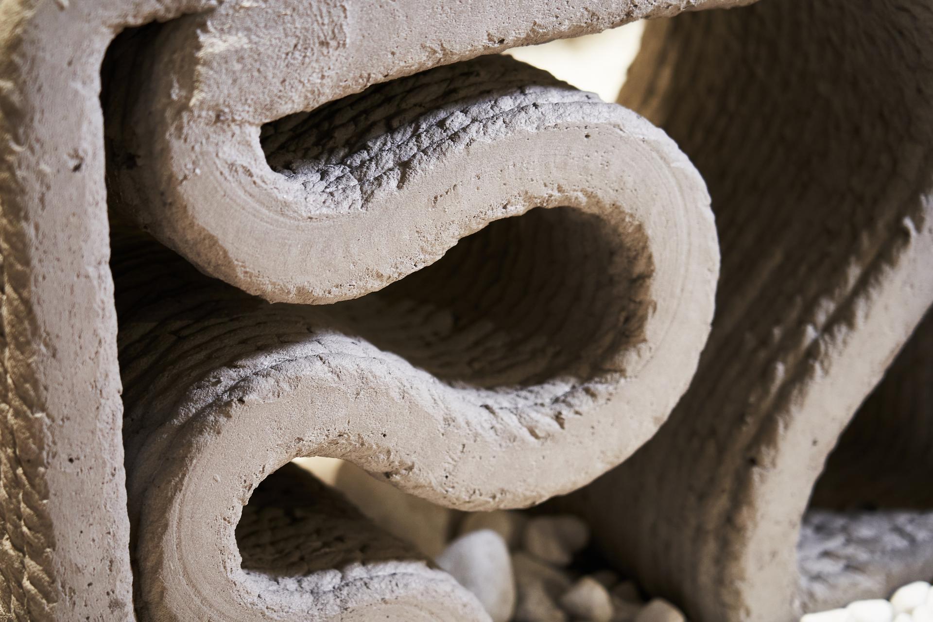 Concrete installation featuring intricate curved designs, showcasing innovative sustainable construction at Material Source Studio in Manchester.