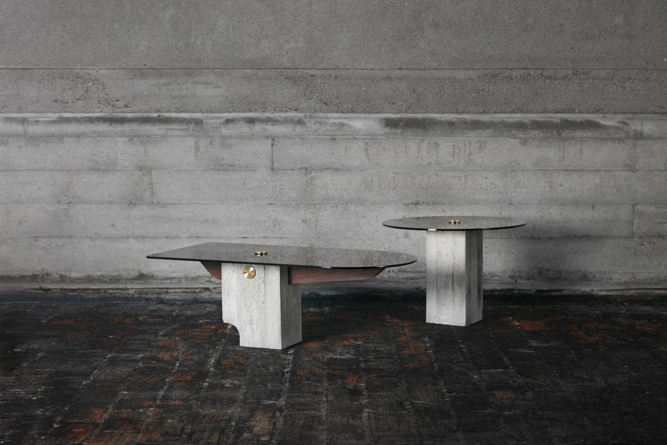 Two contemporary design tables featuring sleek marble tops and geometric concrete bases, inspired by modernist architecture.