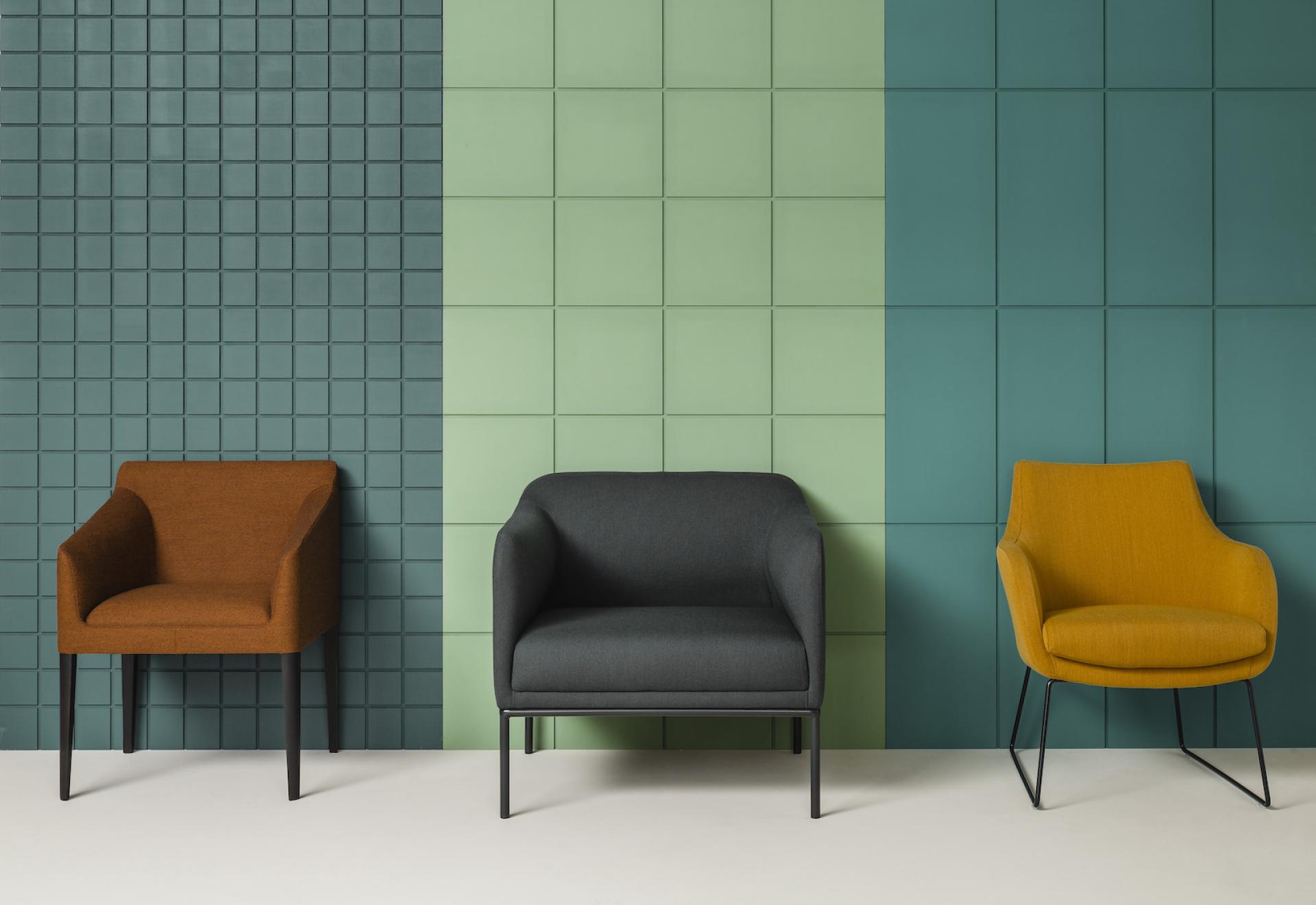 Three stylish armchairs in warm colors against a textured, multicolored wall, showcasing modern furniture design by Roger Lewis.