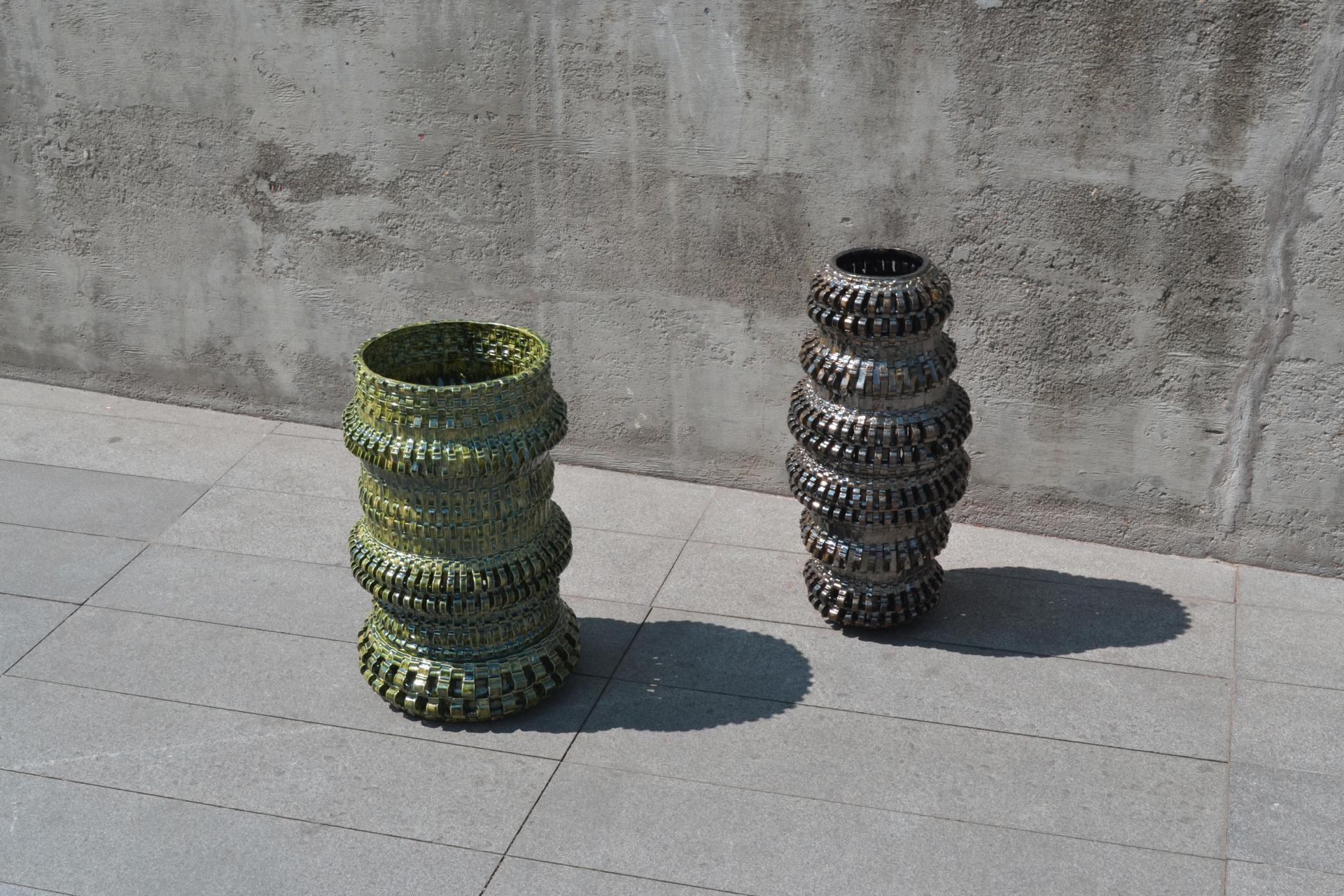 Two unique textile art pieces by Freyja Dorren, showcasing intricate design and vibrant colors, set against a minimalist backdrop.