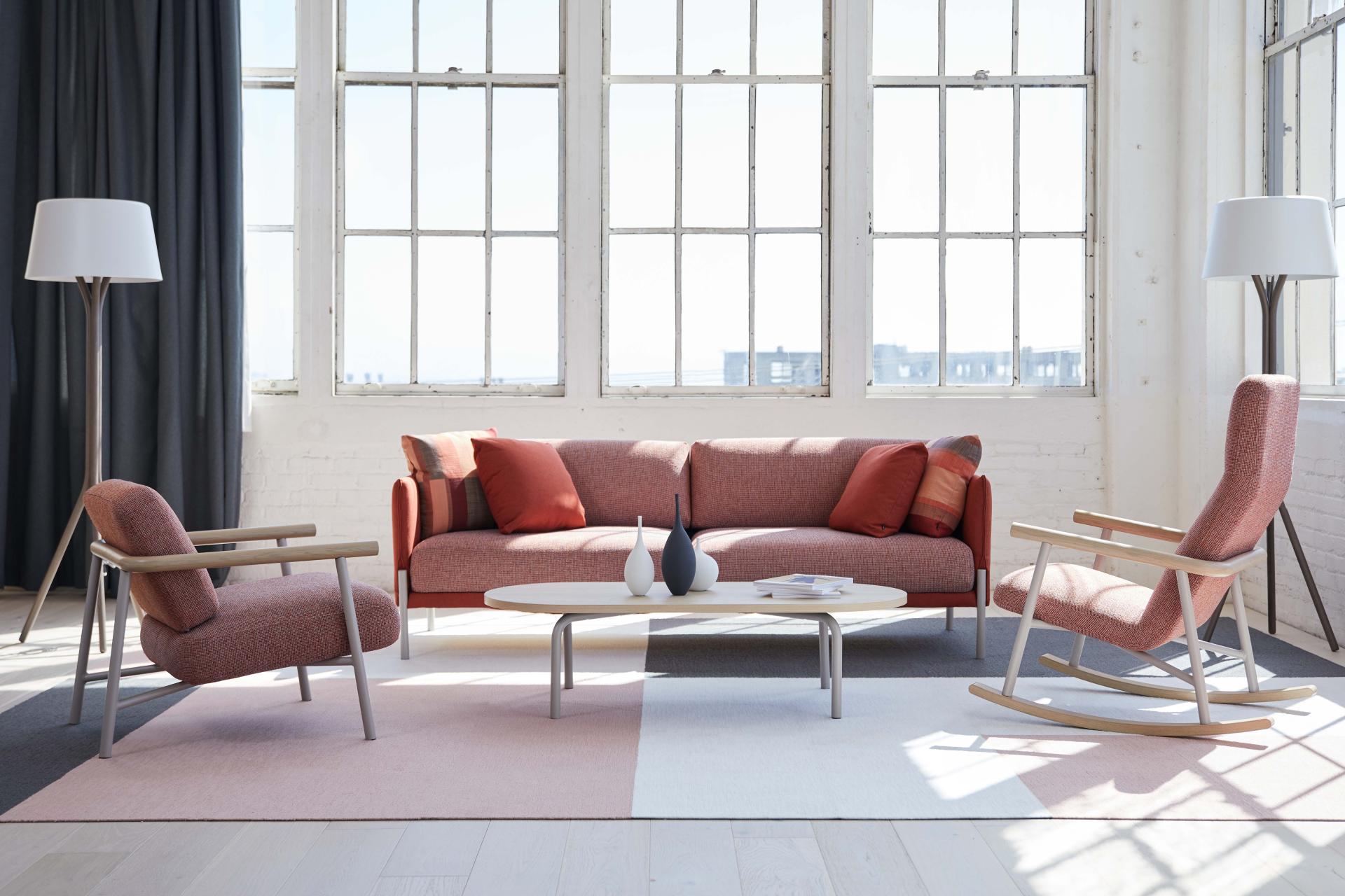 Modern office lounge featuring Pearson Lloyd's Routes furniture collection with a sofa, rocking chair, and stylish coffee table.