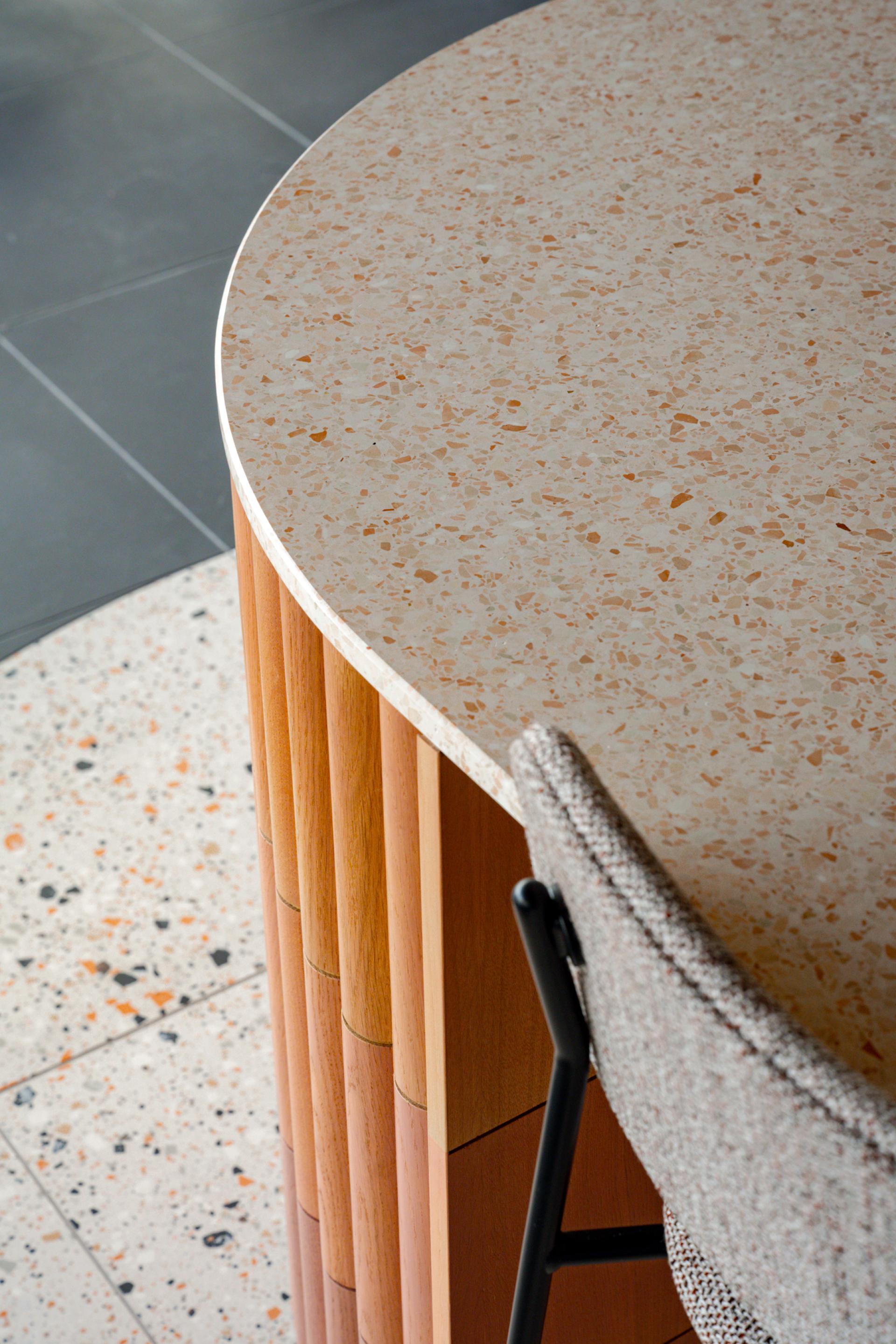 Modern workspace design featuring a terrazzo table surface and textured chair in Dentons' Edinburgh office.