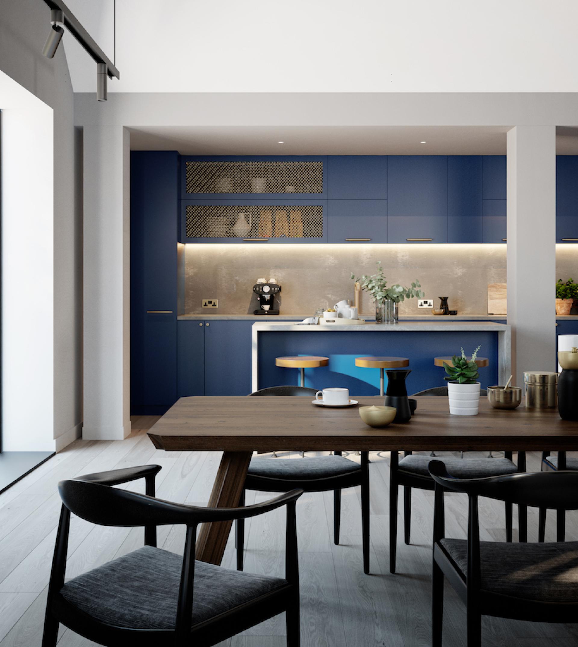 Stylish loft-style kitchen in a luxury penthouse featuring blue cabinetry and a modern dining area at Goodluck Hope.