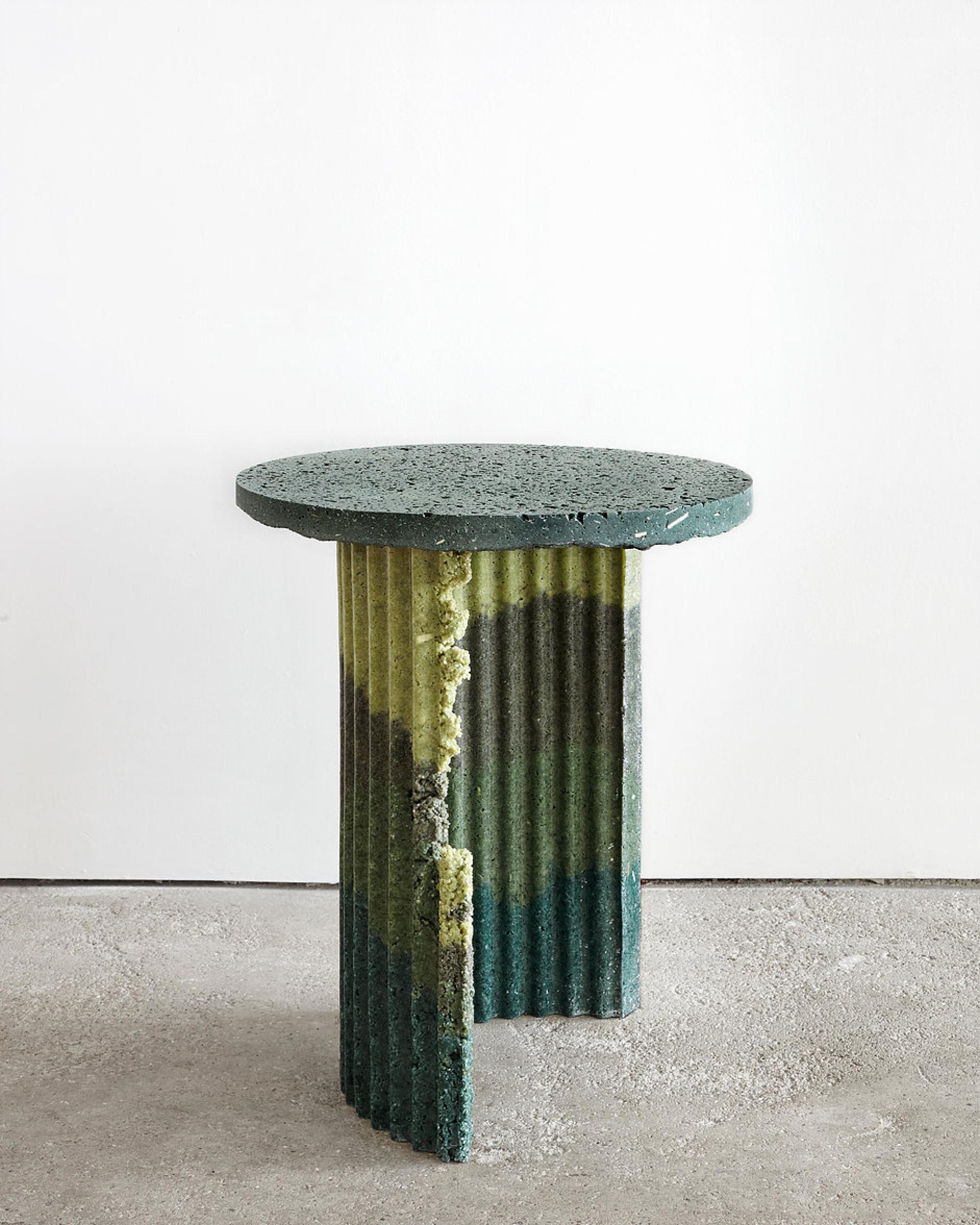 A unique table made from recycled plastic, showcasing a gradient of green and yellow hues, featured at London Design Fair.