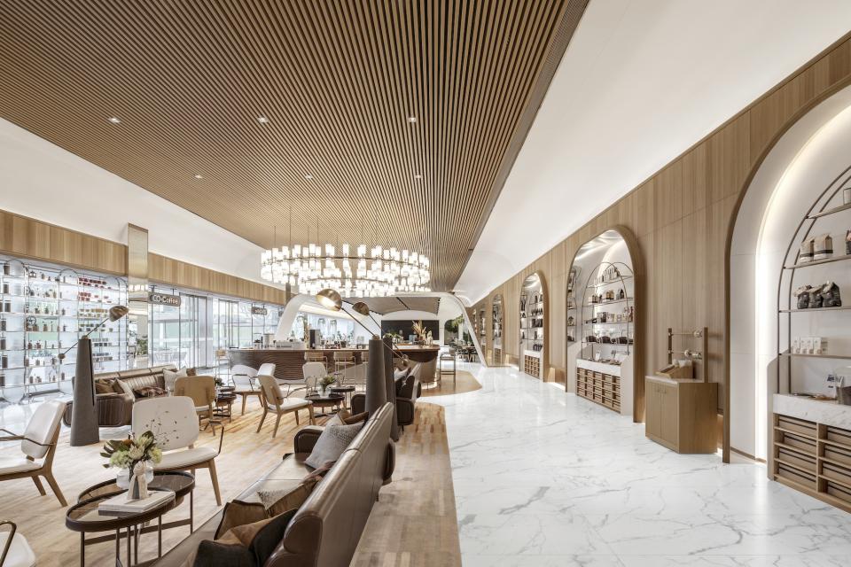 Modern coffee shop interior designed by Karv One, featuring elegant seating, marble flooring, and stylish wooden accents.