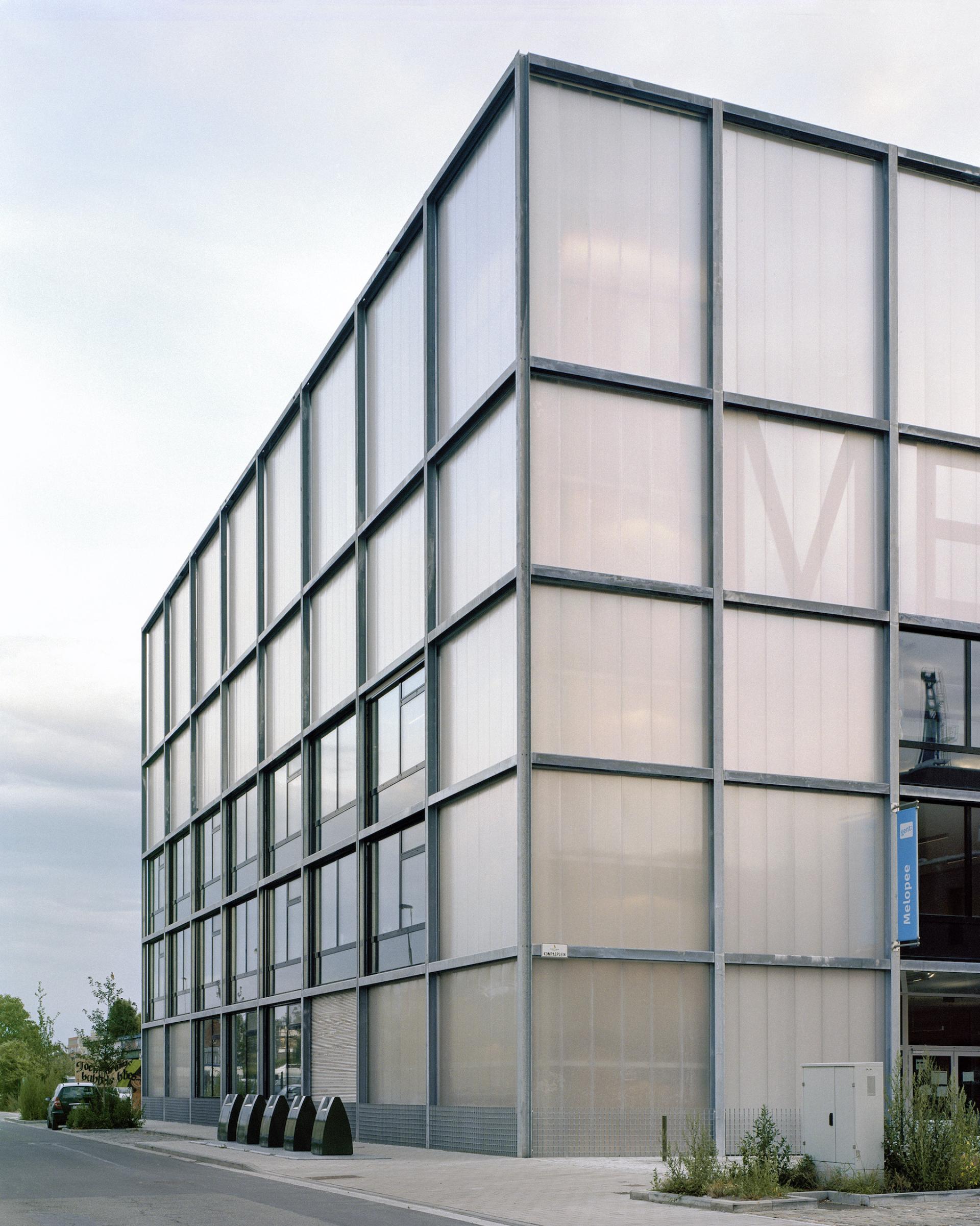 Harbourside multipurpose school by Xaveer De Geyter Architects, featuring a modern glass and steel façade.