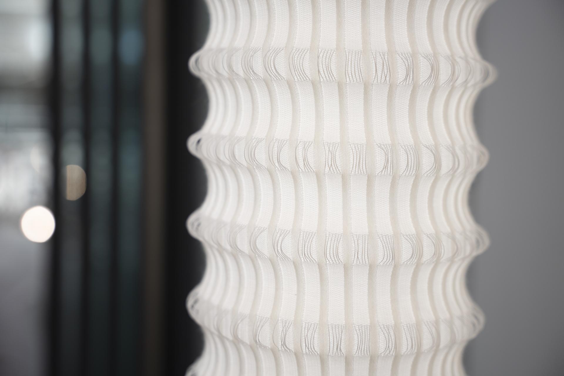 Textured white fabric lamp showcasing innovative design, highlighting material experimentation at New Designers 2024.