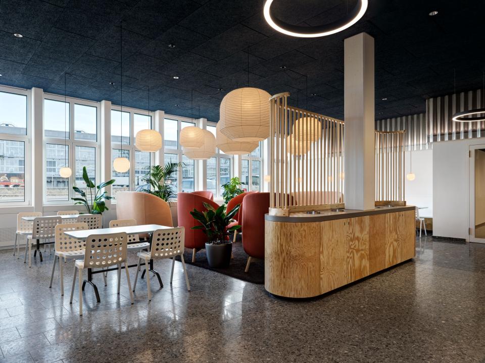 Modern office interior designed by Studio Gessaga, featuring stylish seating, plants, and ample natural light.