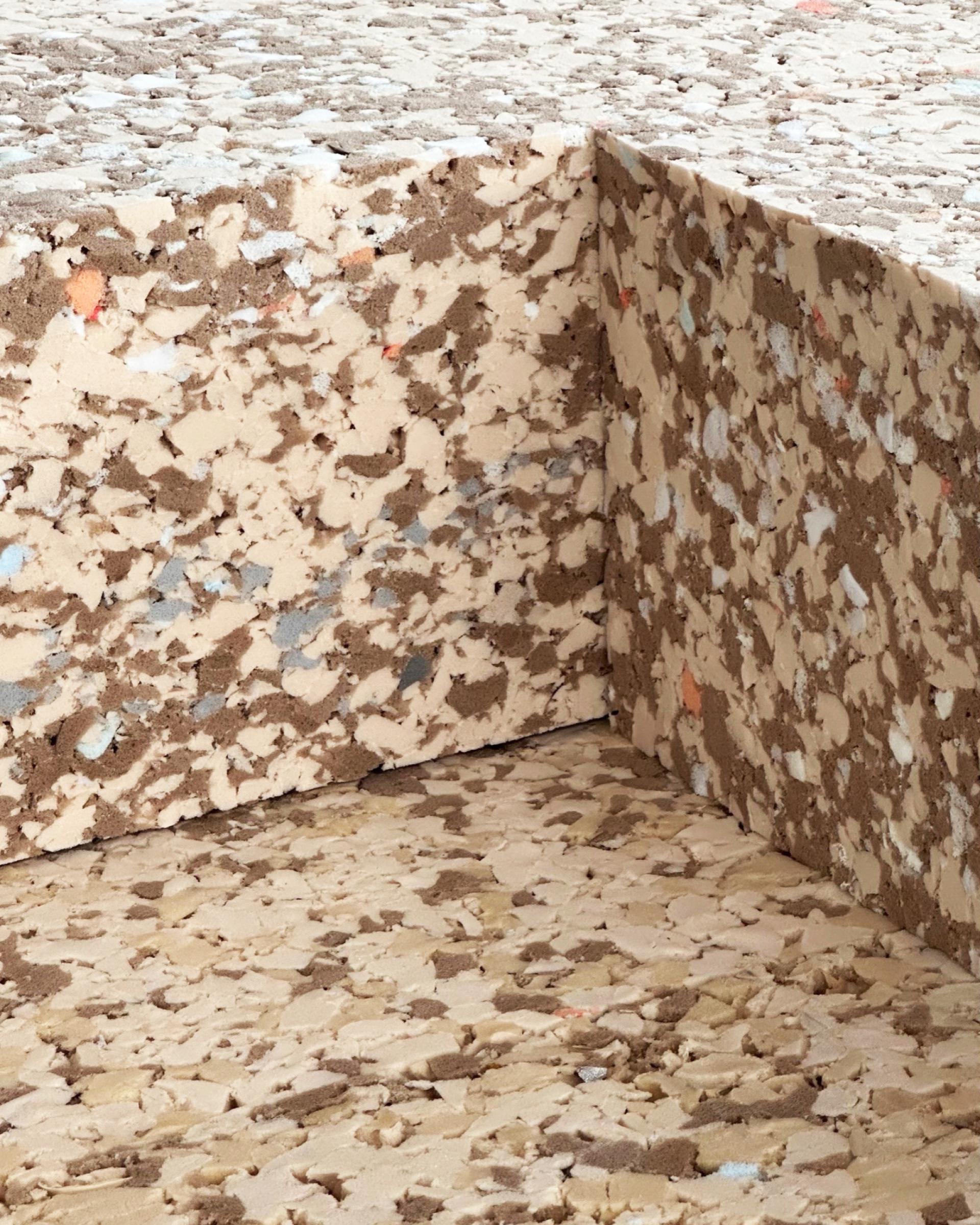 Textured surface of eco-friendly, 100% recycled polyurethane foam bricks used in sustainable construction materials.