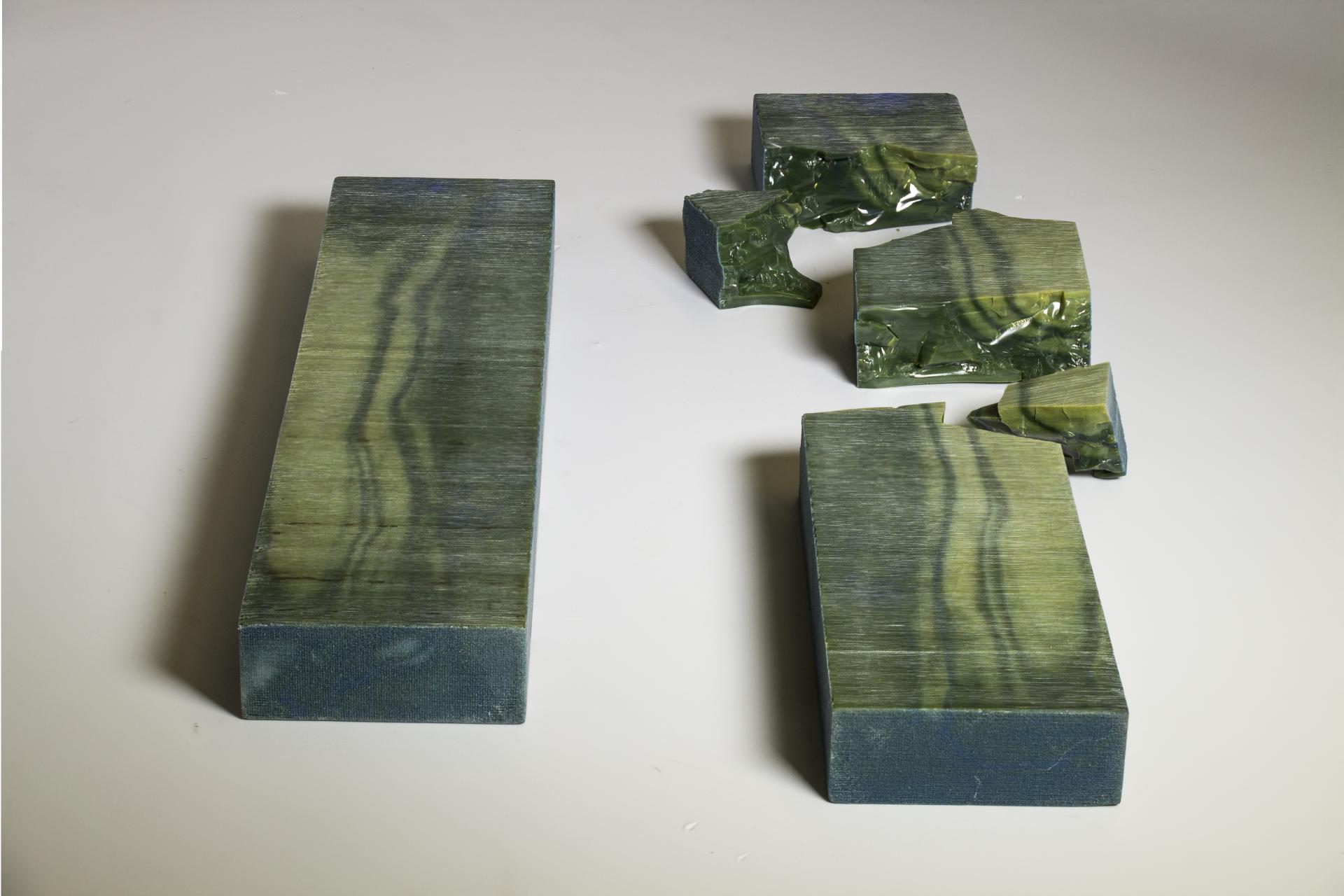 Sustainable wood alternative blocks in green hues, showcasing innovative design and eco-friendly materials for modern furniture.