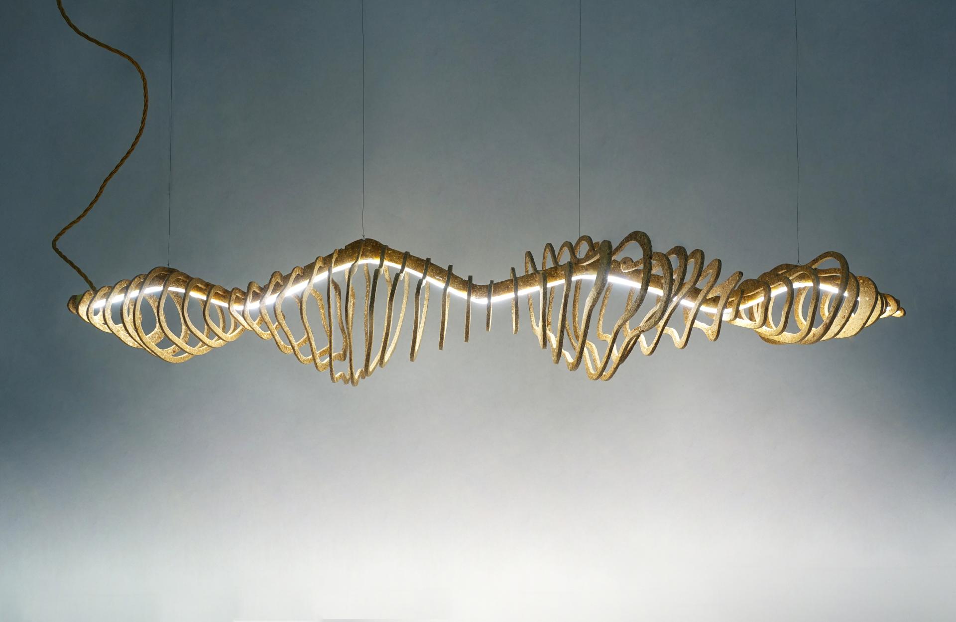 Unique hanging light fixture featuring intricate spiral design, symbolizing BIOHM's innovative and nature-driven approach in crowdfunding campaign.