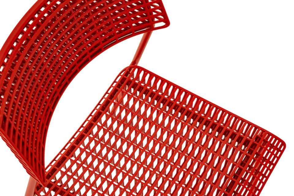 Stylish red CALA chair by Martin Ballendat, showcasing a modern design with a functional, stackable structure.