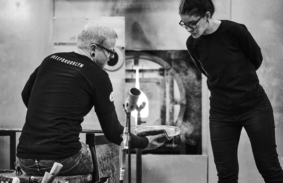 Glass artisans Susan Spiranovich and Adam collaborate in the KEEP Brooklyn studio, focusing on glassblowing techniques.