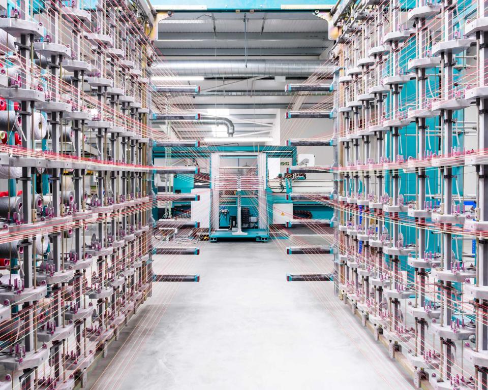 Upholstery textile production machinery at Kvadrat, showcasing advanced technology and intricate thread systems in action.