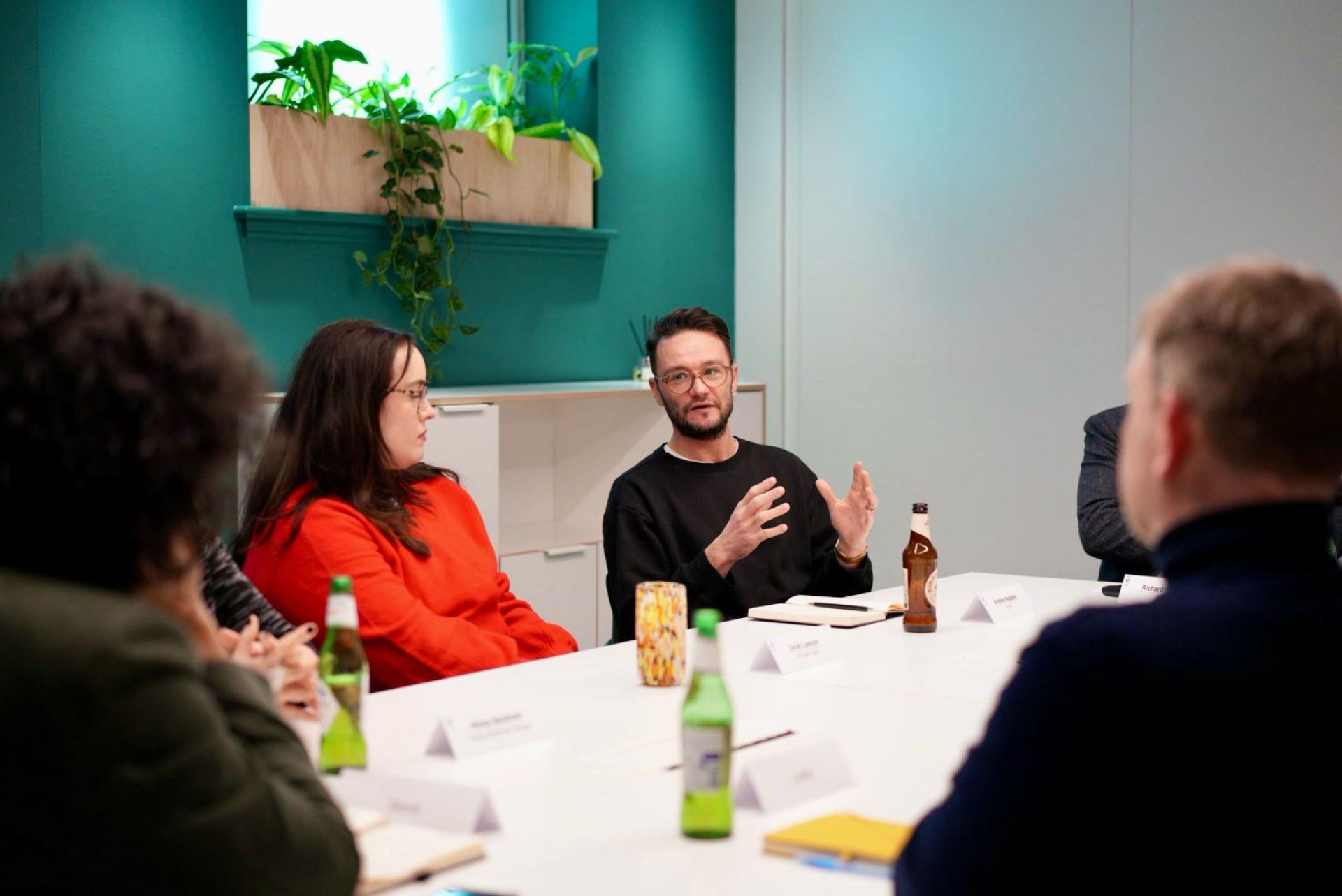 Group discussion on workplace flexibility with diverse participants in a modern meeting room setting.