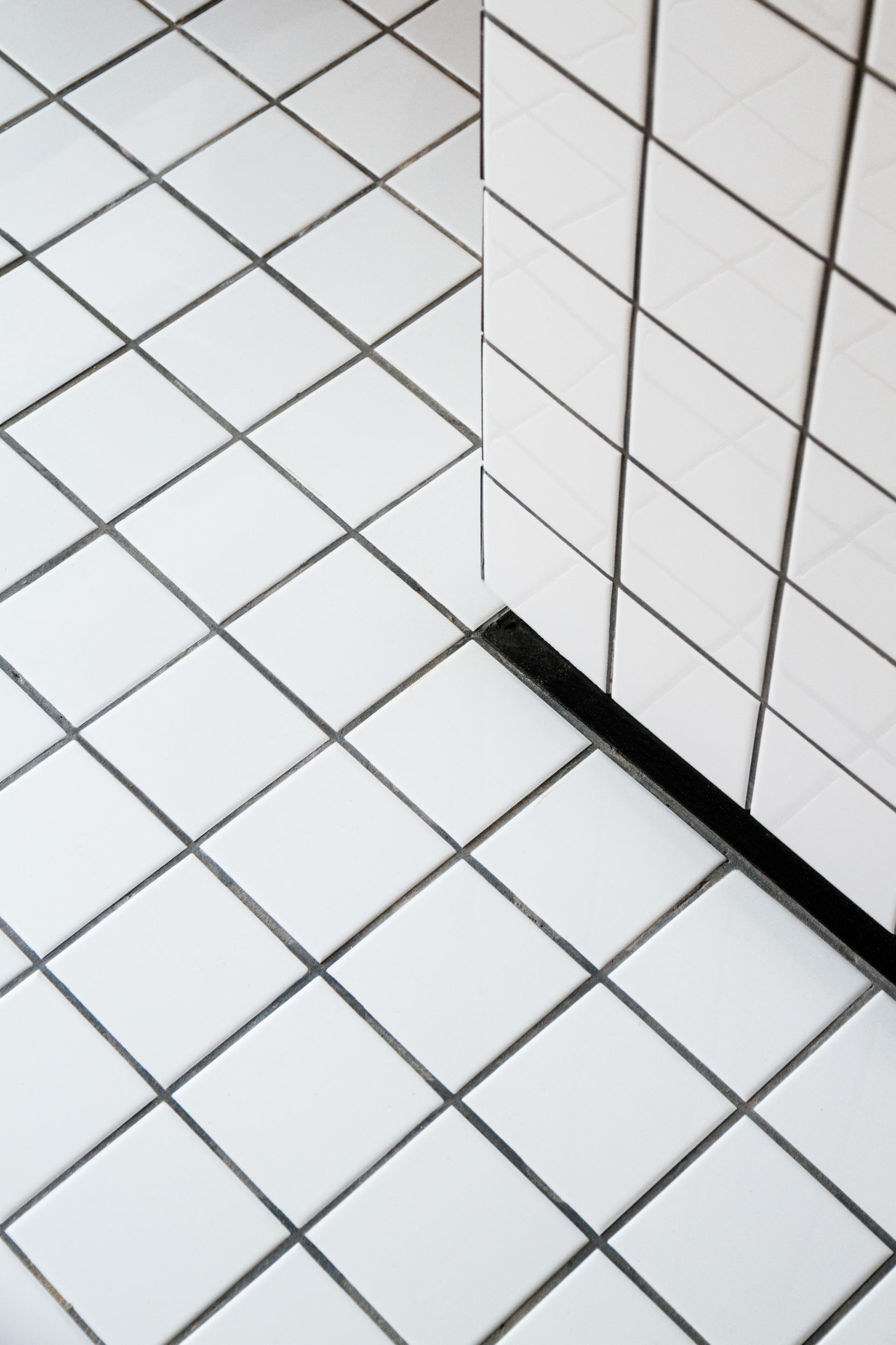Modern white ceramic tiles in a geometric pattern, showcasing innovative design in architectural interior spaces.
