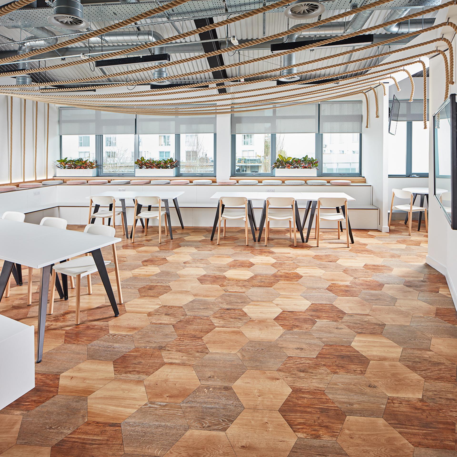 Stylish interior featuring Karndean luxury vinyl flooring in a hexagonal wood design, complemented by modern furniture and natural light.
