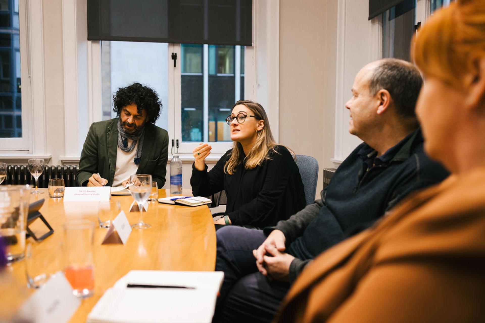 Professionals engaging in discussion during a seminar on Glasgow's property outlook, highlighting market trends and future insights.