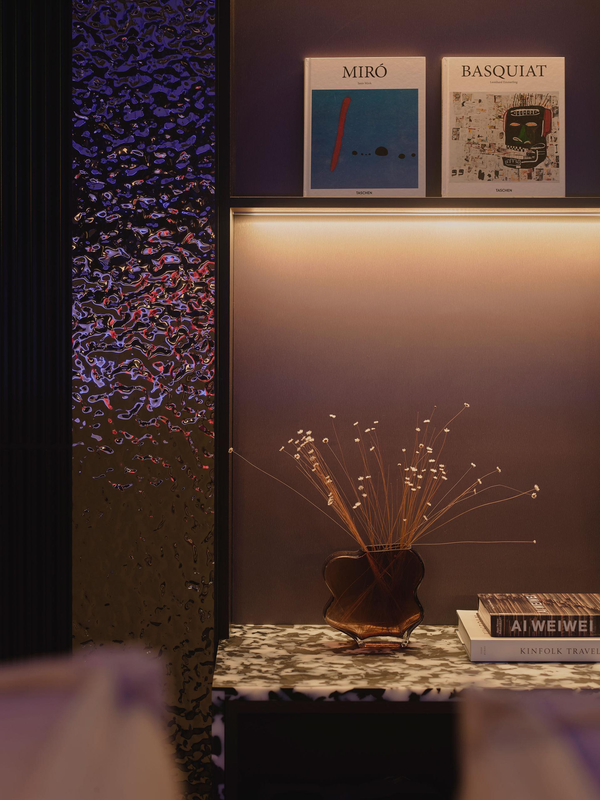 Elegant interior display featuring art books, floral arrangement, and modern design elements at 16-18 Potterrow, Edinburgh.