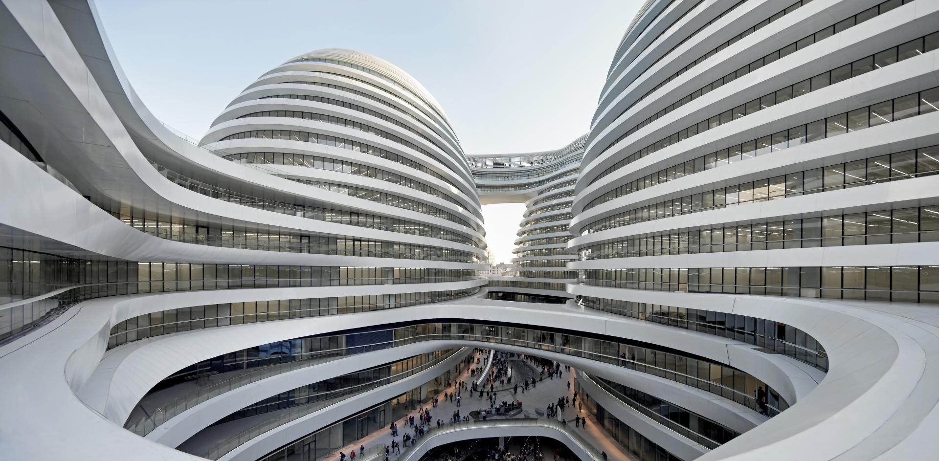 Modern architectural design featuring Zaha Hadid's iconic curvilinear structures at a bustling urban setting in Shanghai.