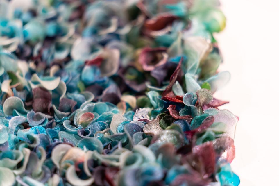 Colorful abstract artwork made from layered materials, celebrating creativity in the exhibition "From The Ground Up."