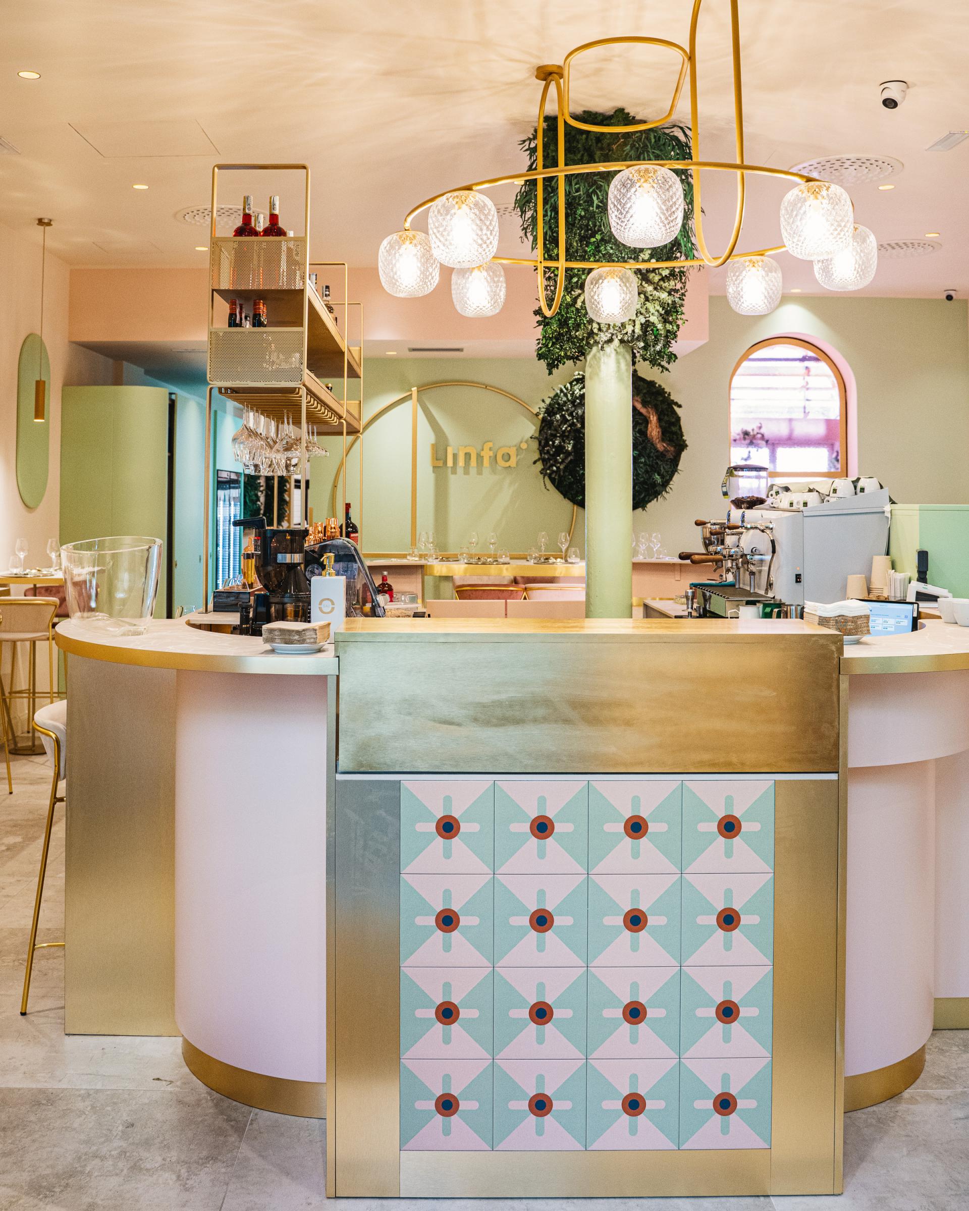 Stylish bar counter at Linfa Milano featuring elegant decor and vibrant patterned tiles, showcasing S•CAB furnishings.