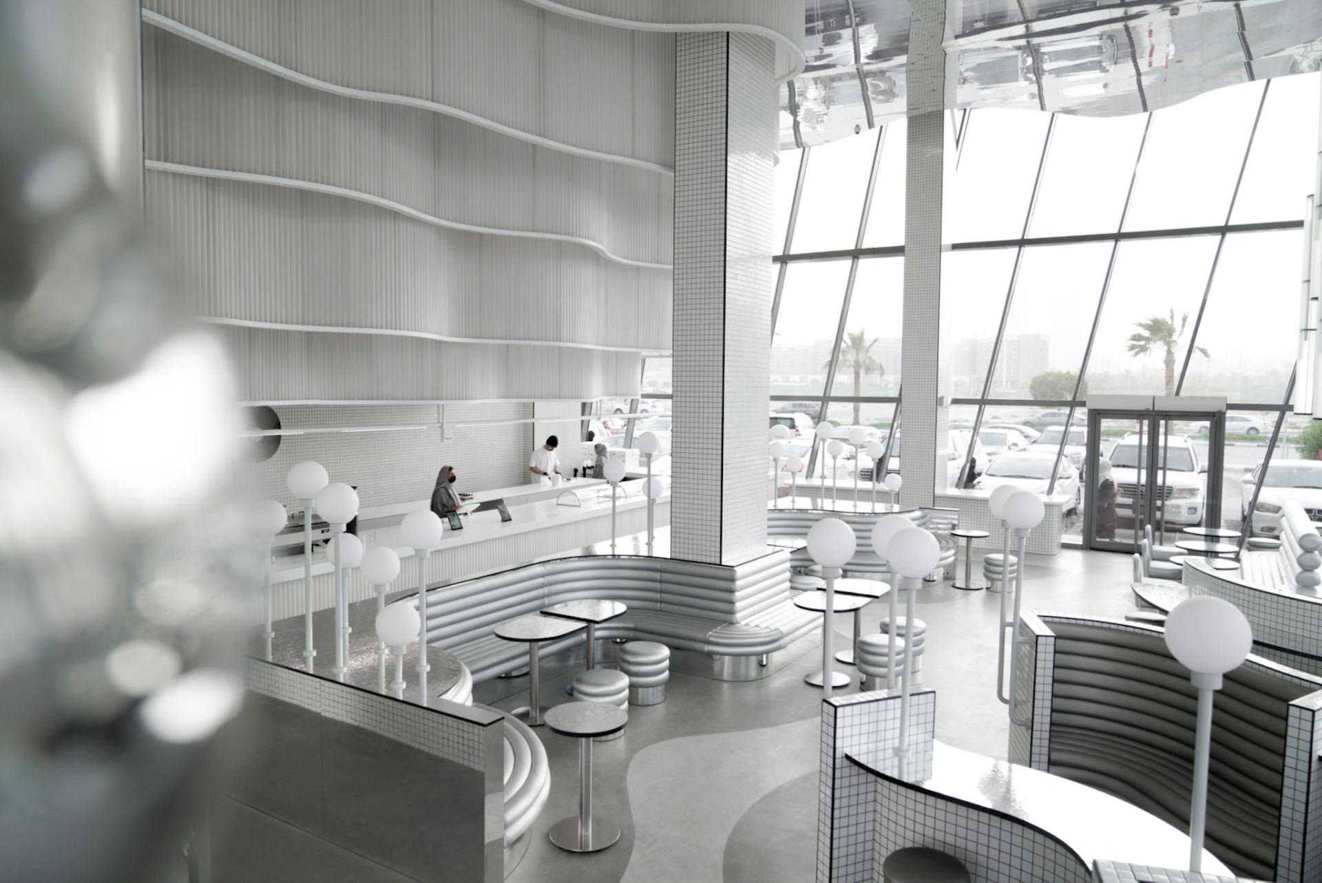 Modern interior design of MO bakehouse and espresso bar in Khobar, featuring sleek curves and abundant natural light.
