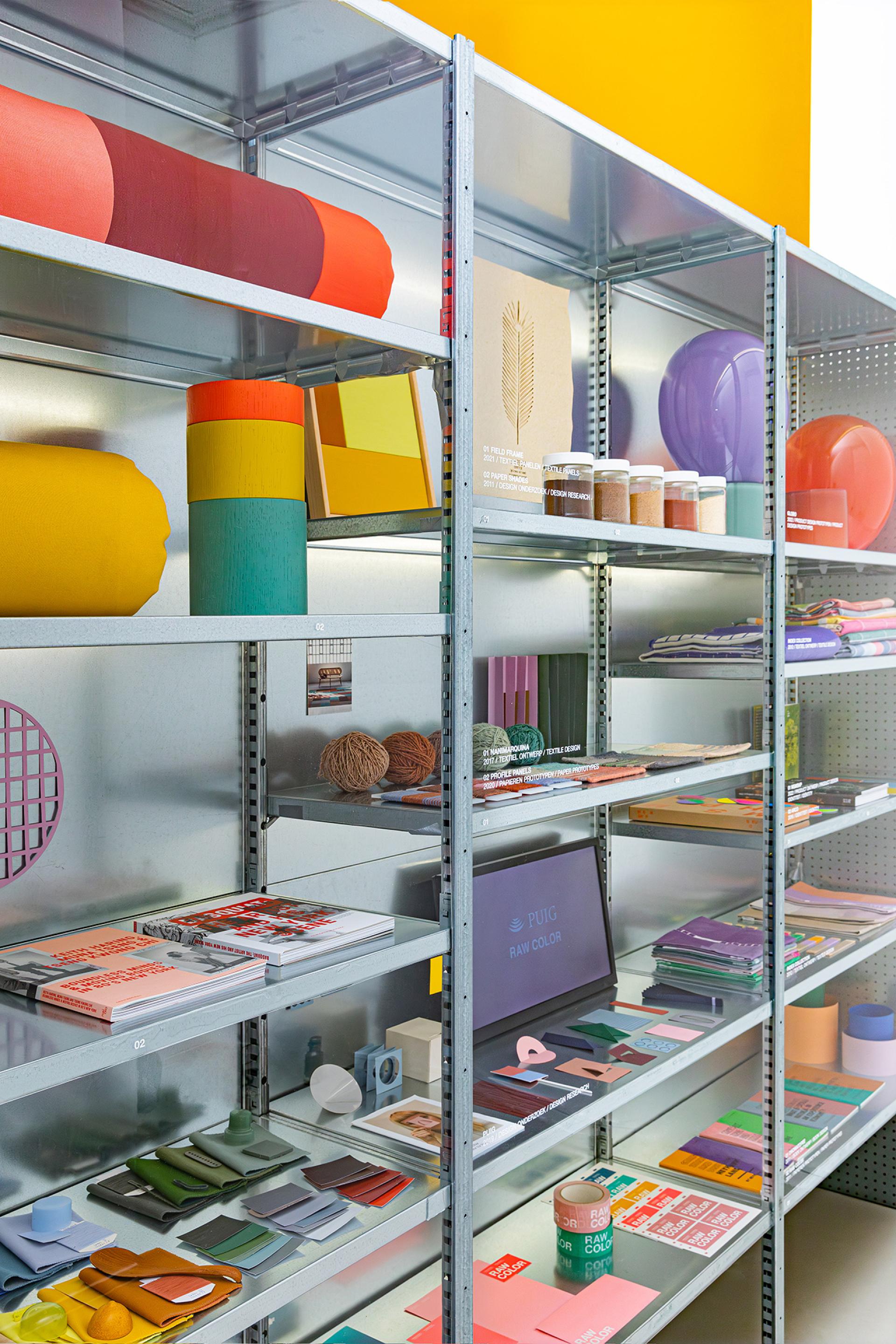 Colorful shelves display bio-based materials, diverse palettes, and design resources reflecting Raw Color's innovative approach to materials.