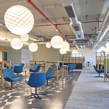 Modern interior of Heriot-Watt University's new Dubai campus featuring stylish seating, innovative lighting, and collaborative spaces.