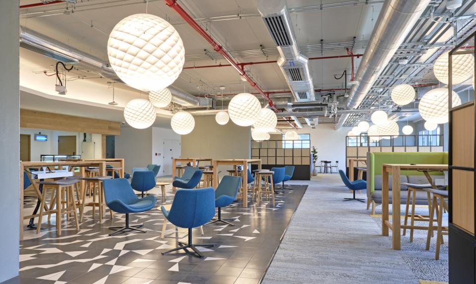 Modern interior of Heriot-Watt University's new Dubai campus featuring stylish seating, innovative lighting, and collaborative spaces.